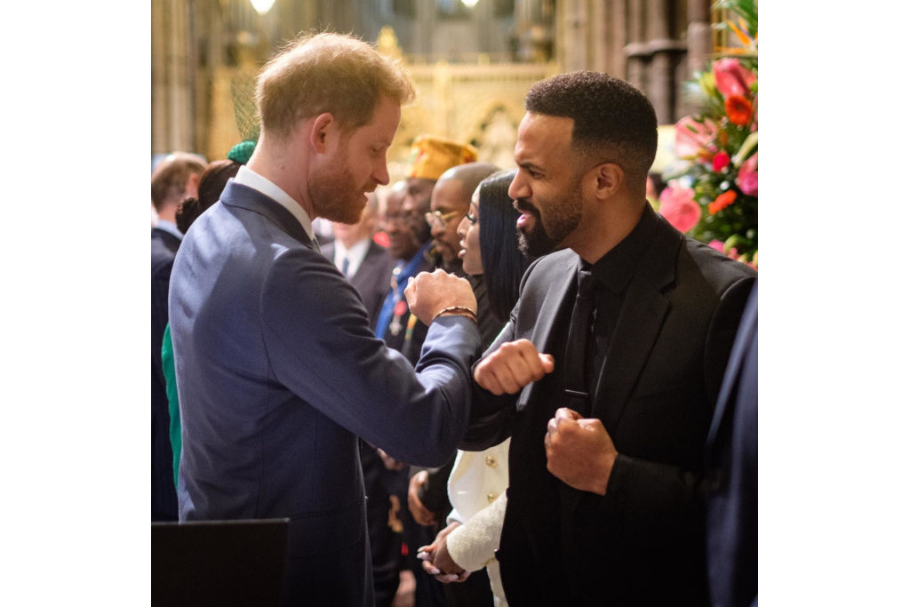 Prince Harry touching elbows with Craig David