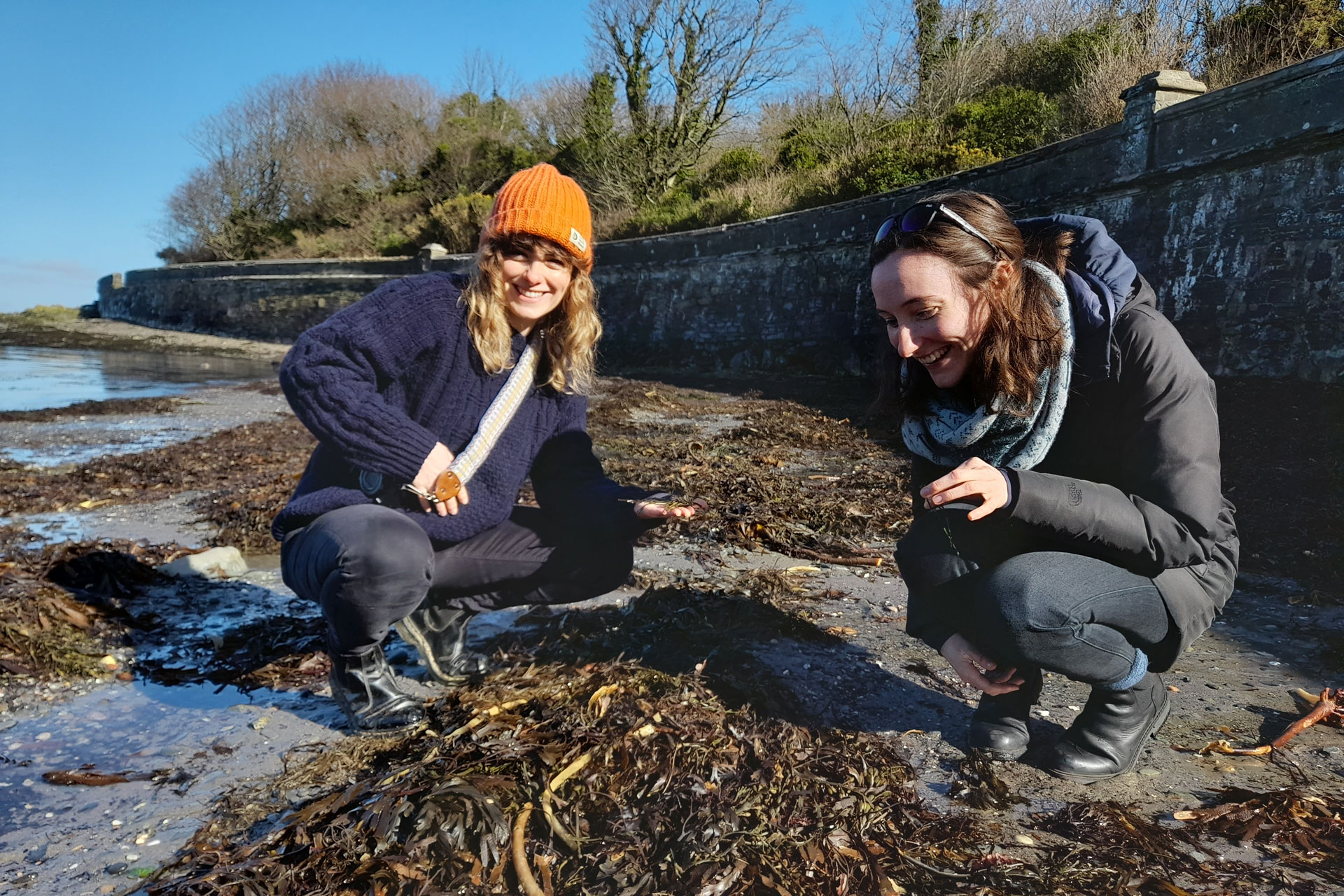 Two women exploring the shore of the Isle of Man