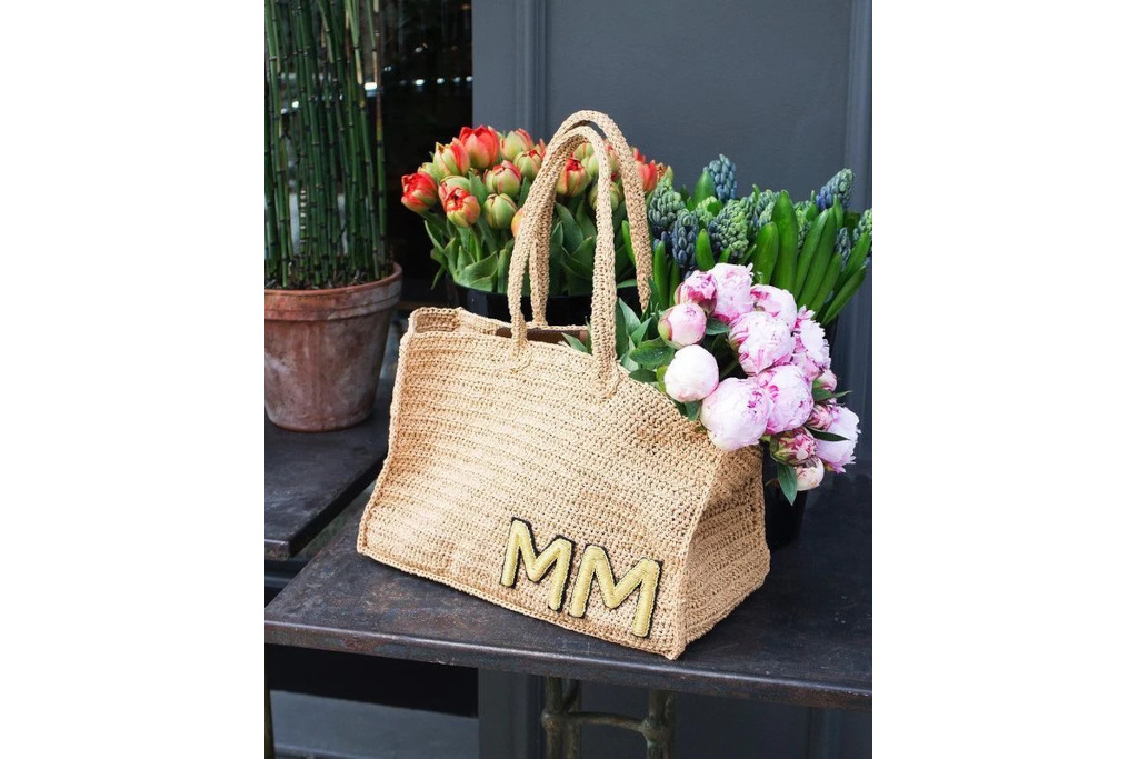 Tote bag sat on table with flowers