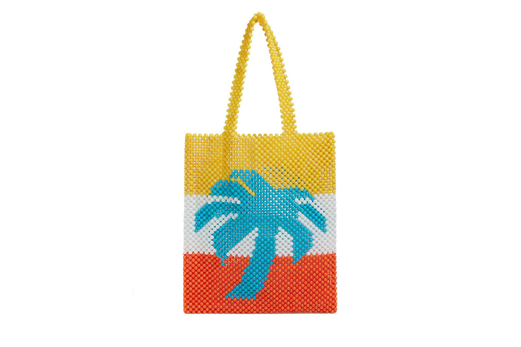 Yellow, white and red striped beaded bag with blue palm tree on the front