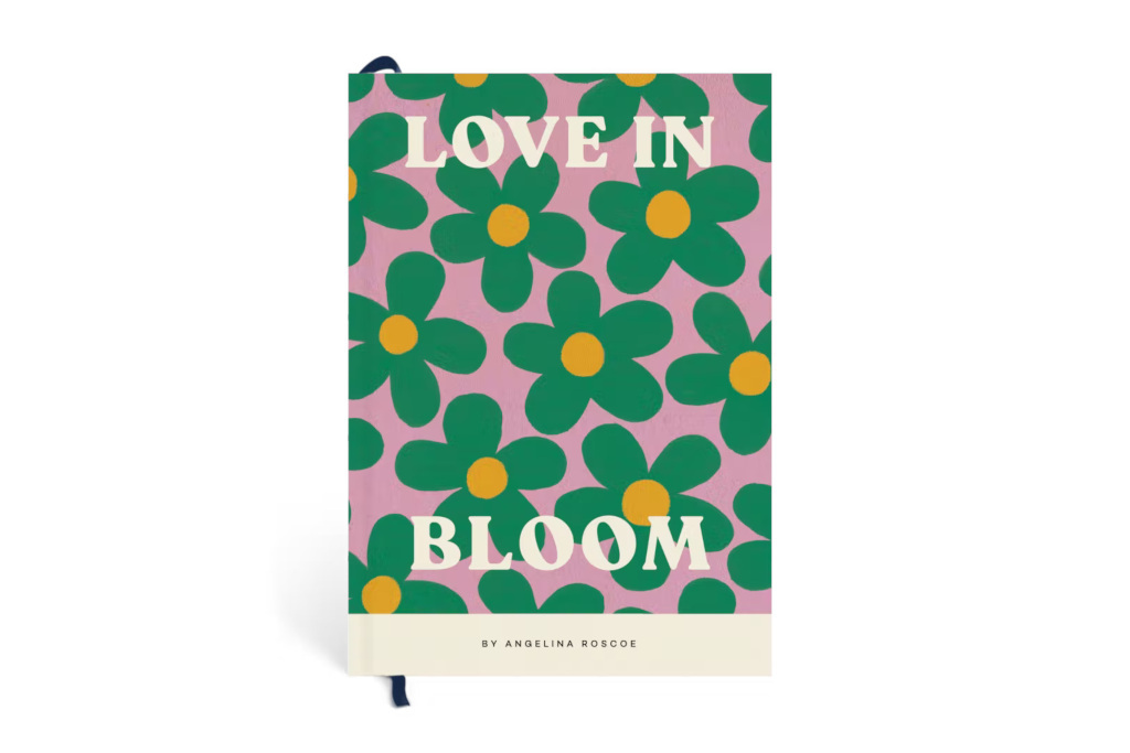 Notebook with pink background with green flowers, text on front says 'Love in Bloom, by Angelina Roscoe'