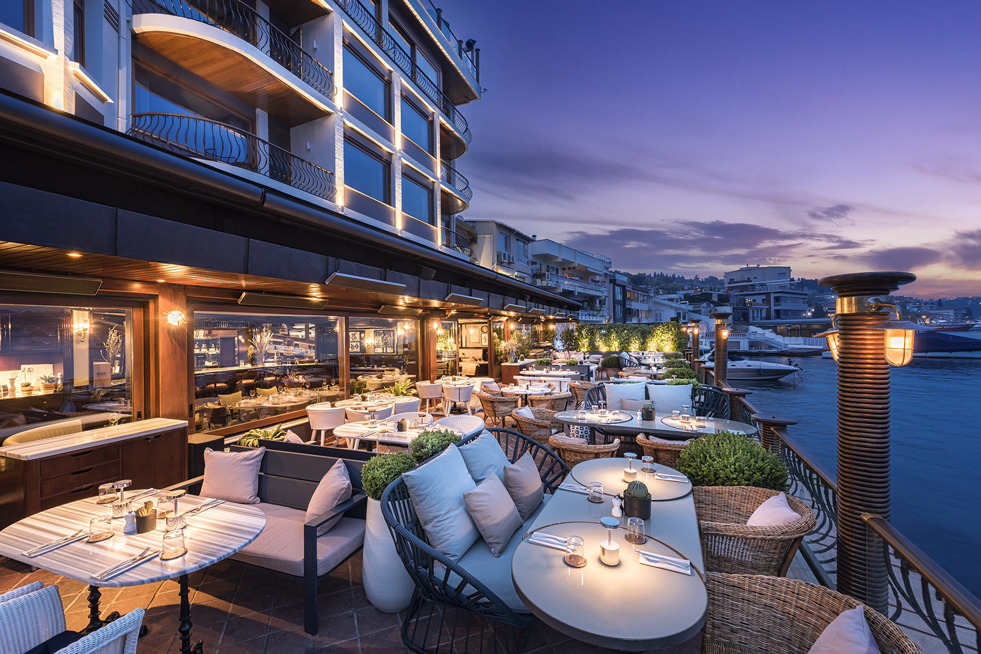 Chairs and sun loungers at dusk on the terrace at The Bebek Hotel by The Stay