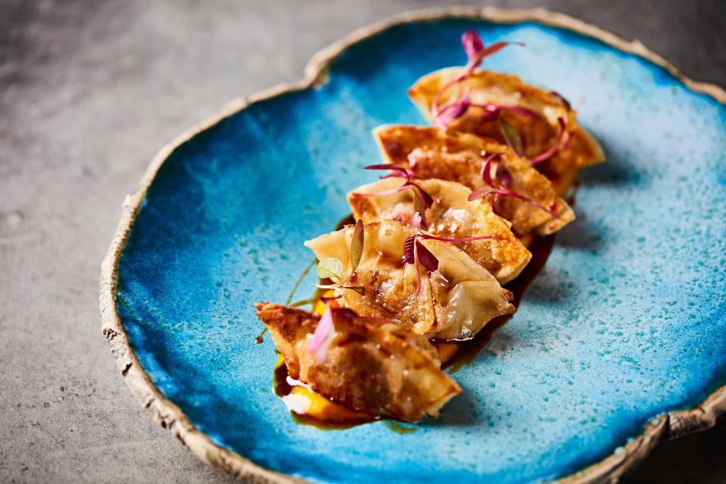 gyozas on blue plate at sushisamba 