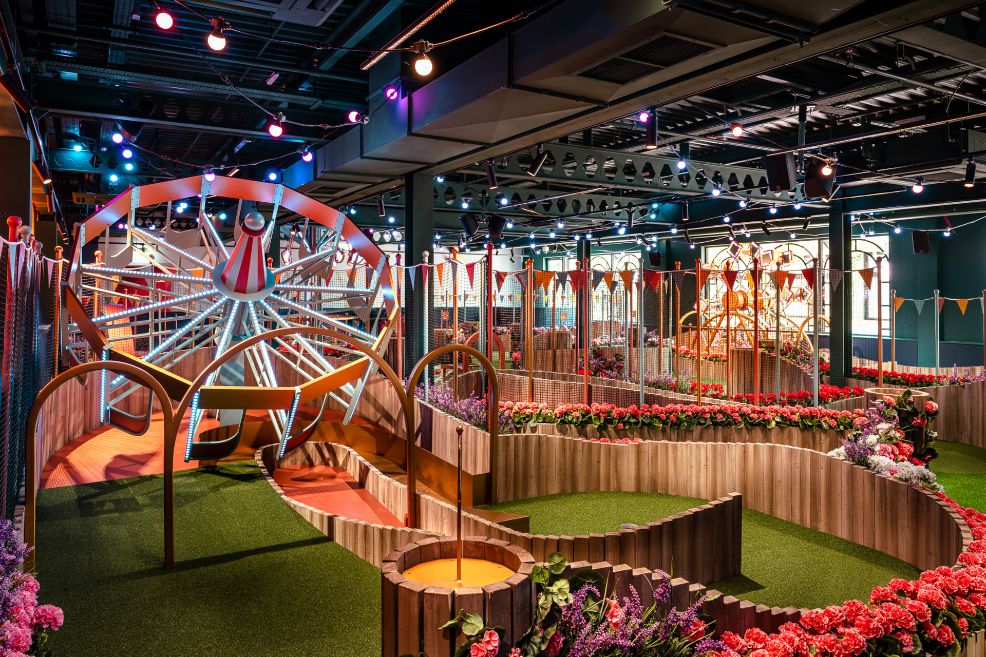 Indoor crazy golf course with fairground theme