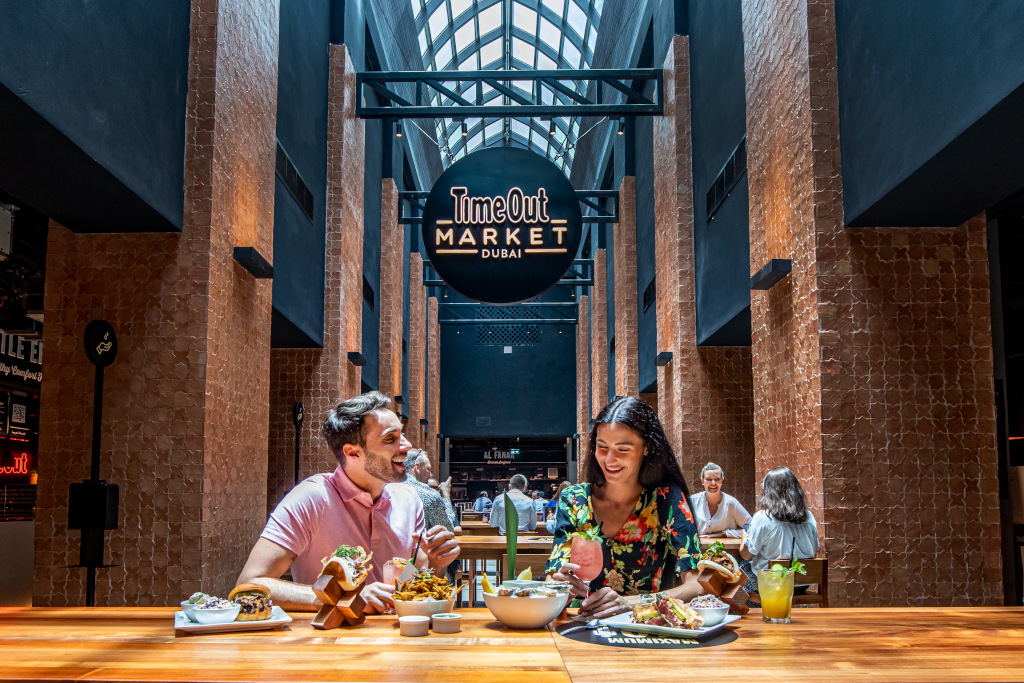 Man and woman eating together atTime Out Market Duba