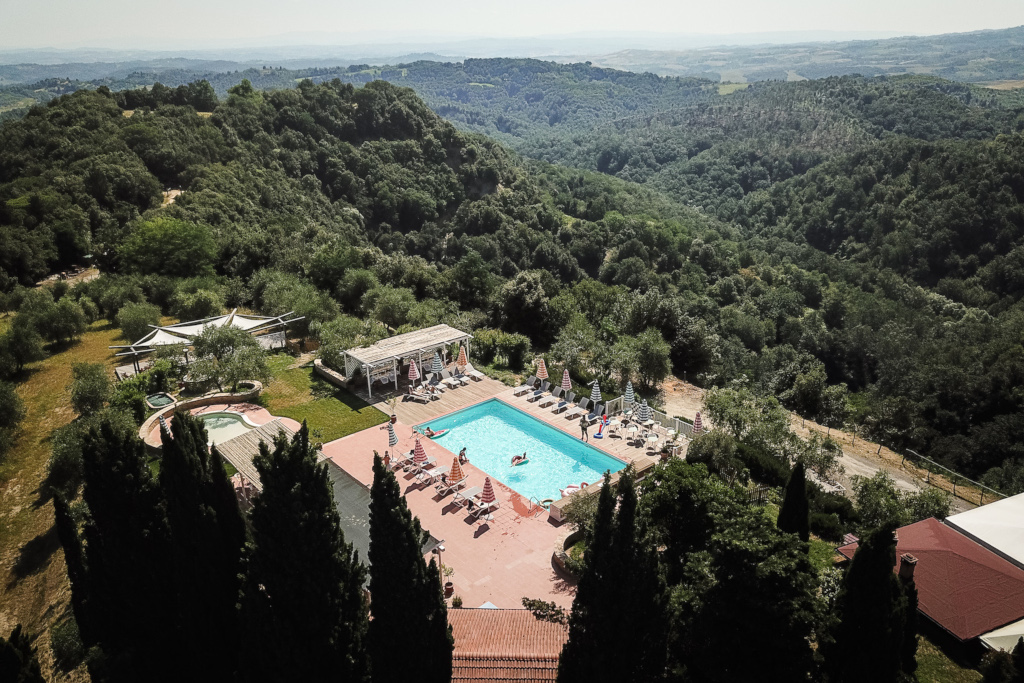 Aerial view over pool in Tuscan hills