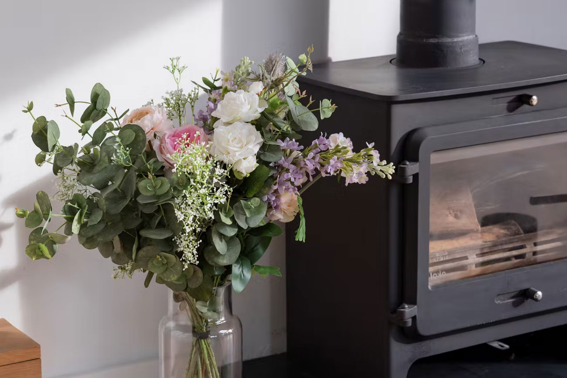 a bouquet of fake flowers next to a stove