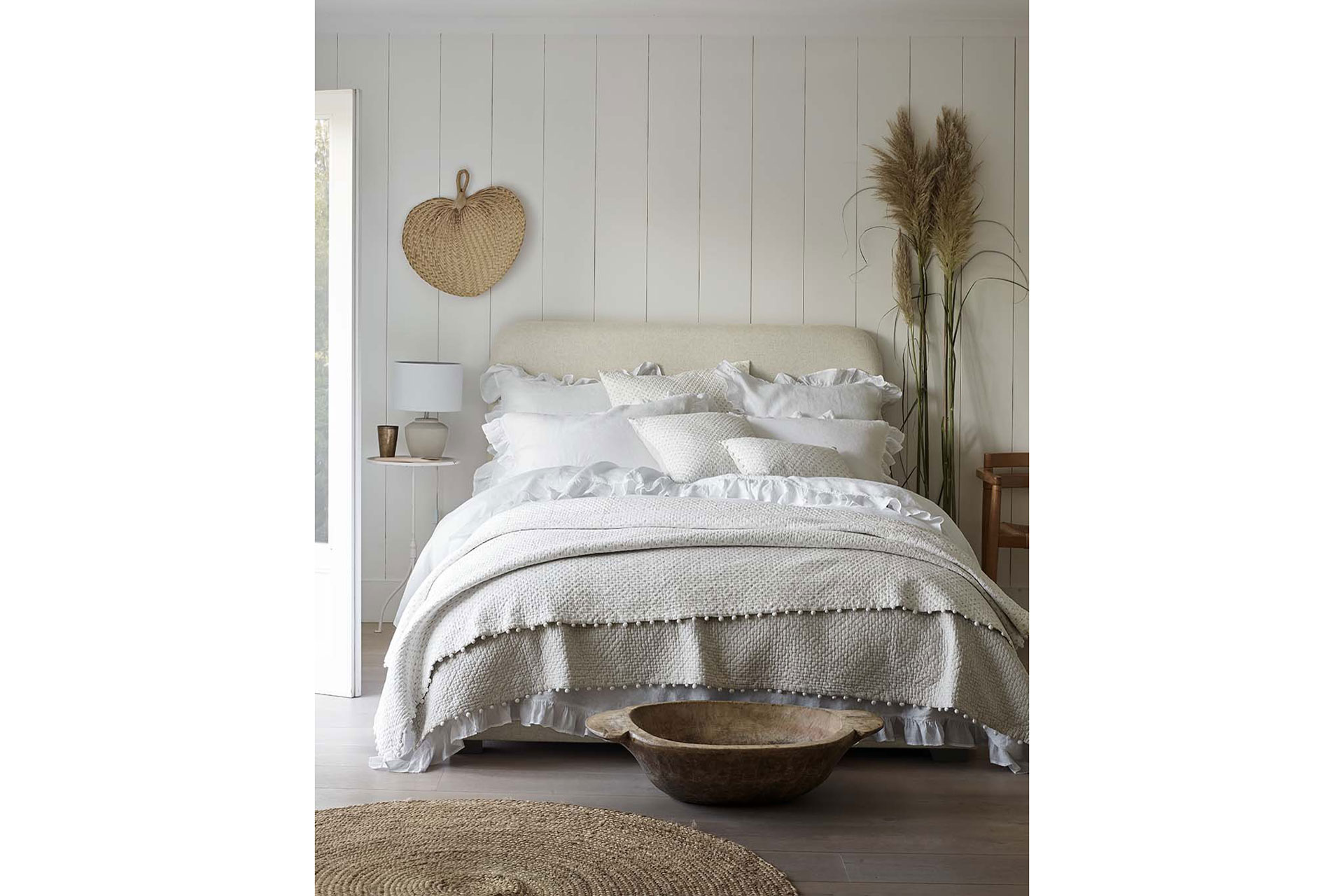 a bed with neutral colours by The White Company
