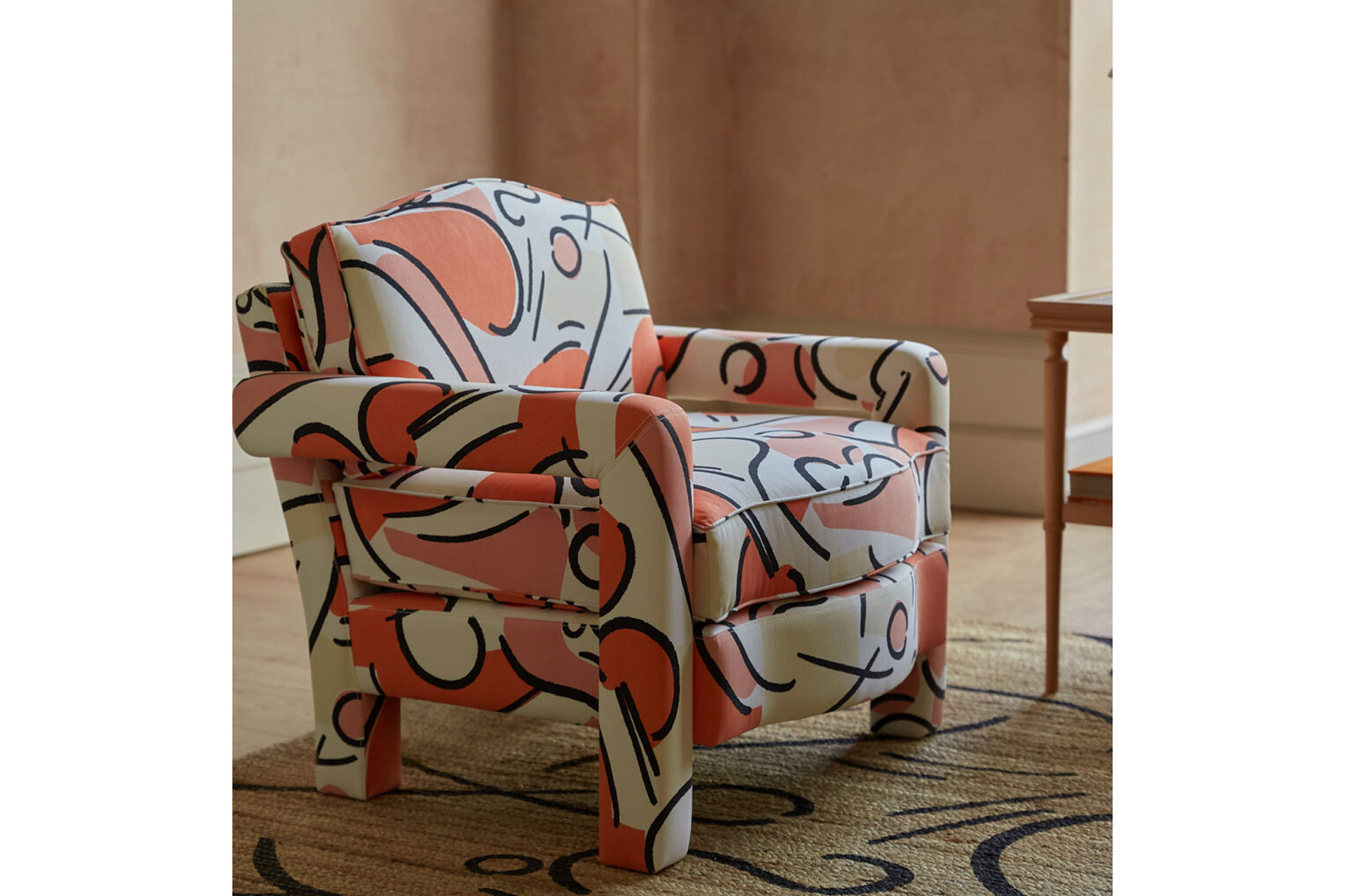 The Elio Armchair is a pink and white swirly design, created by Ceraudo