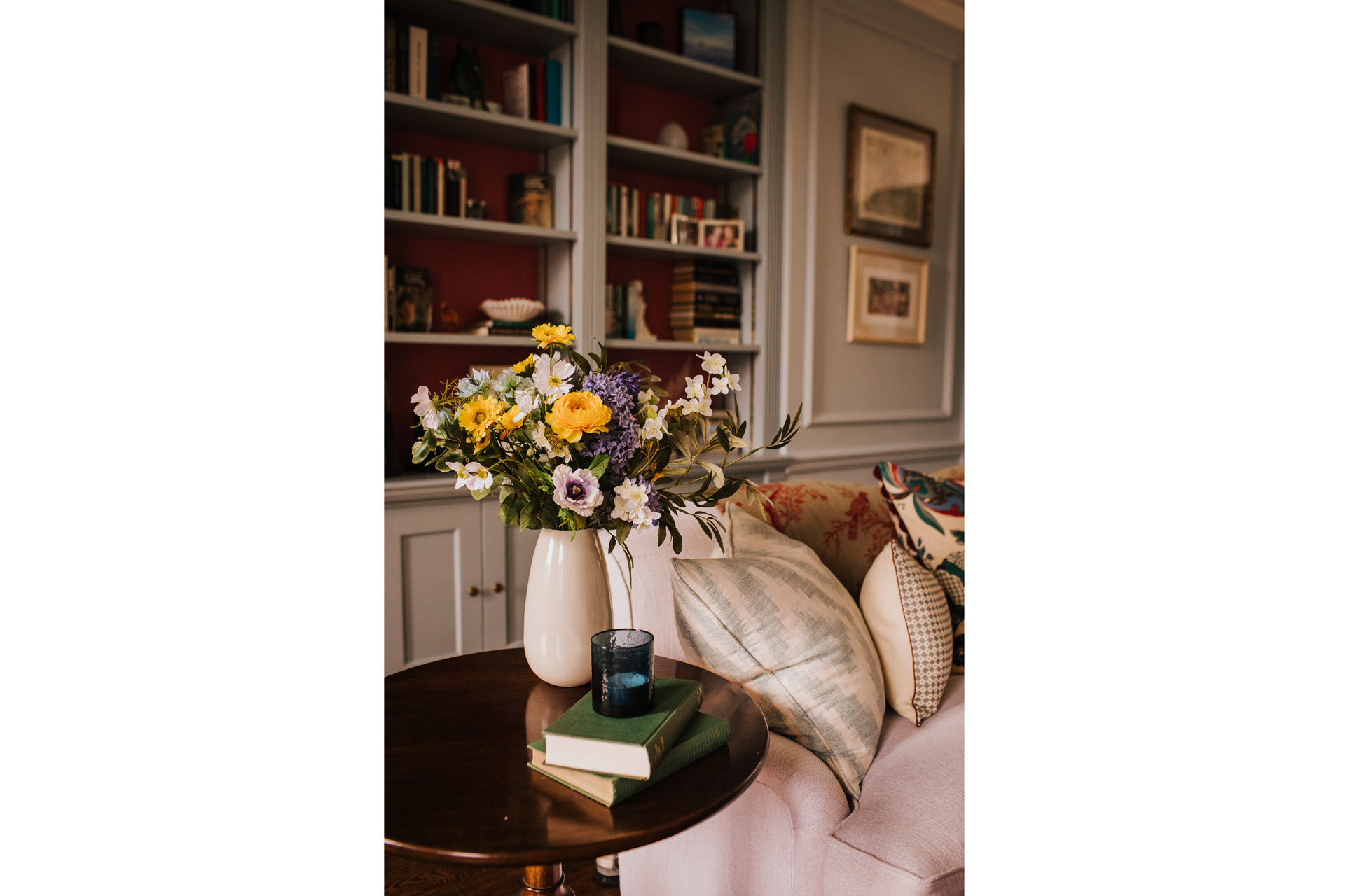 The Daisy Bouquet by Hoax, it's a artificial bouquet of flowers in a smart English living room with books and grey panelled walls