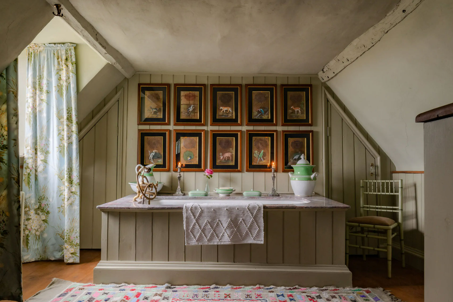 a historic looking bathroom with wood pannelled walls with the colour eau de nile by Edward Bulmer