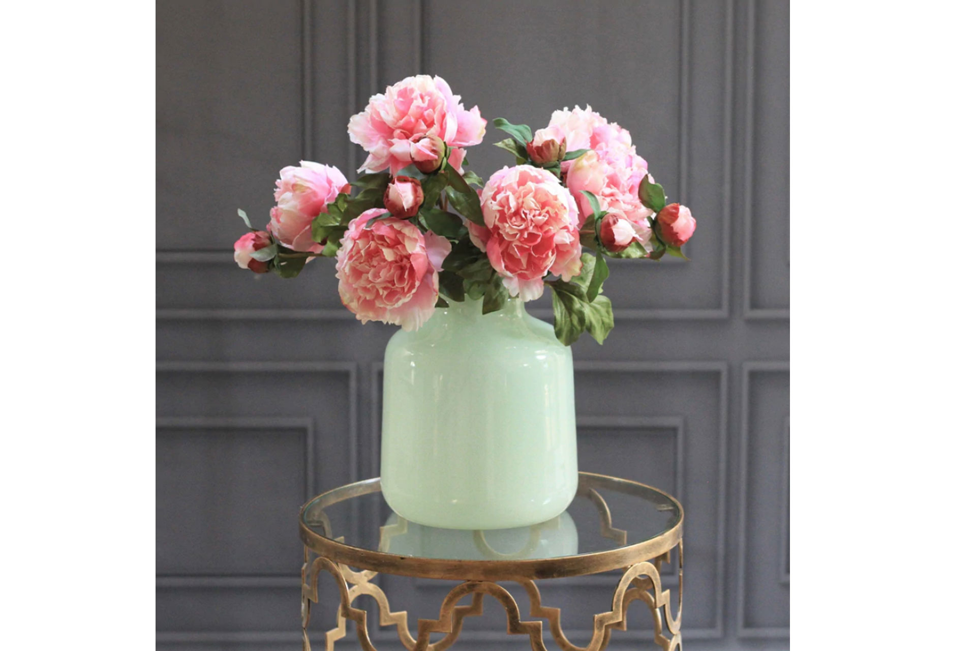 a vase of fake pink peonies