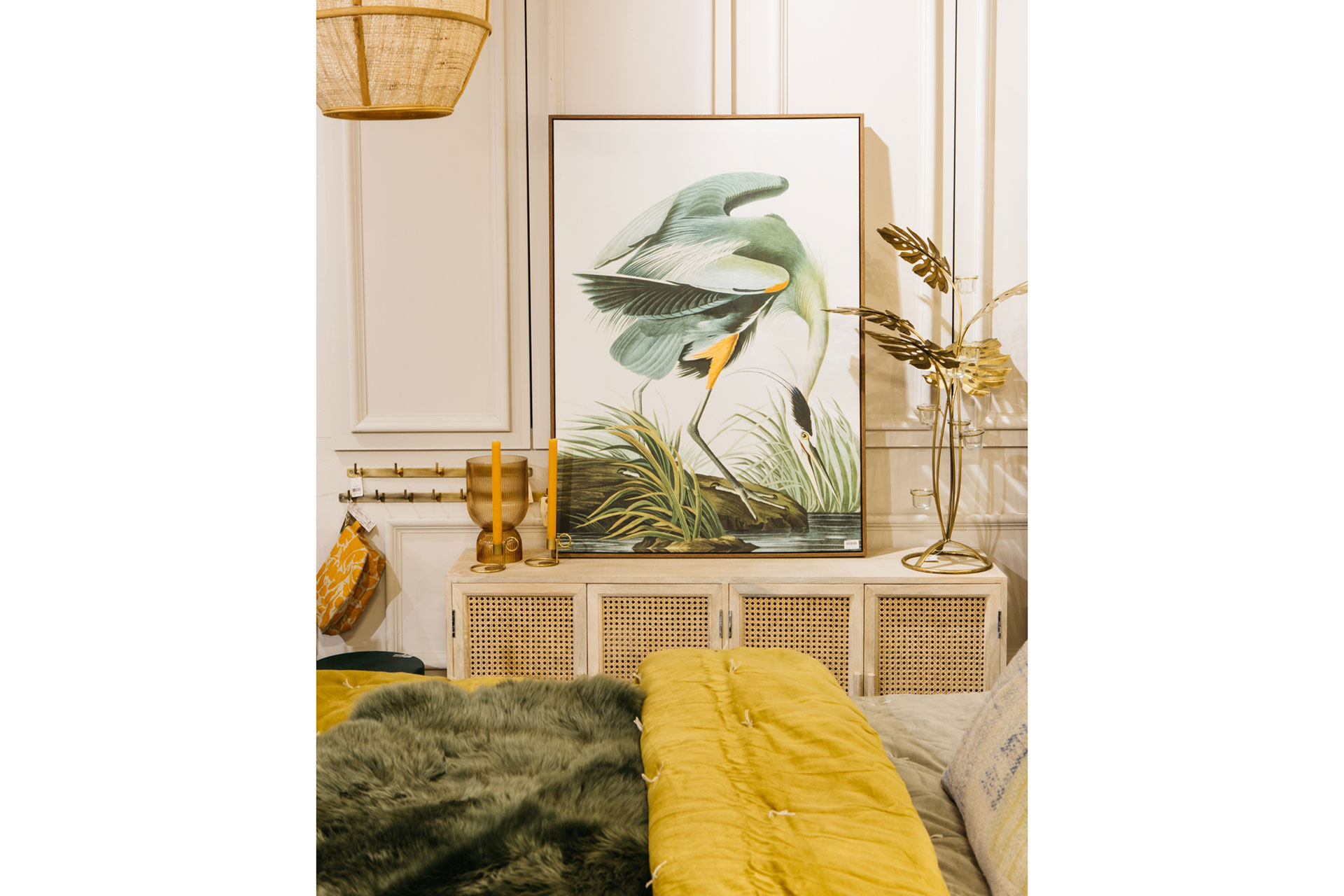 a bedroom with a swan antique painting with greens and yellow interior decoration by Graham & Green