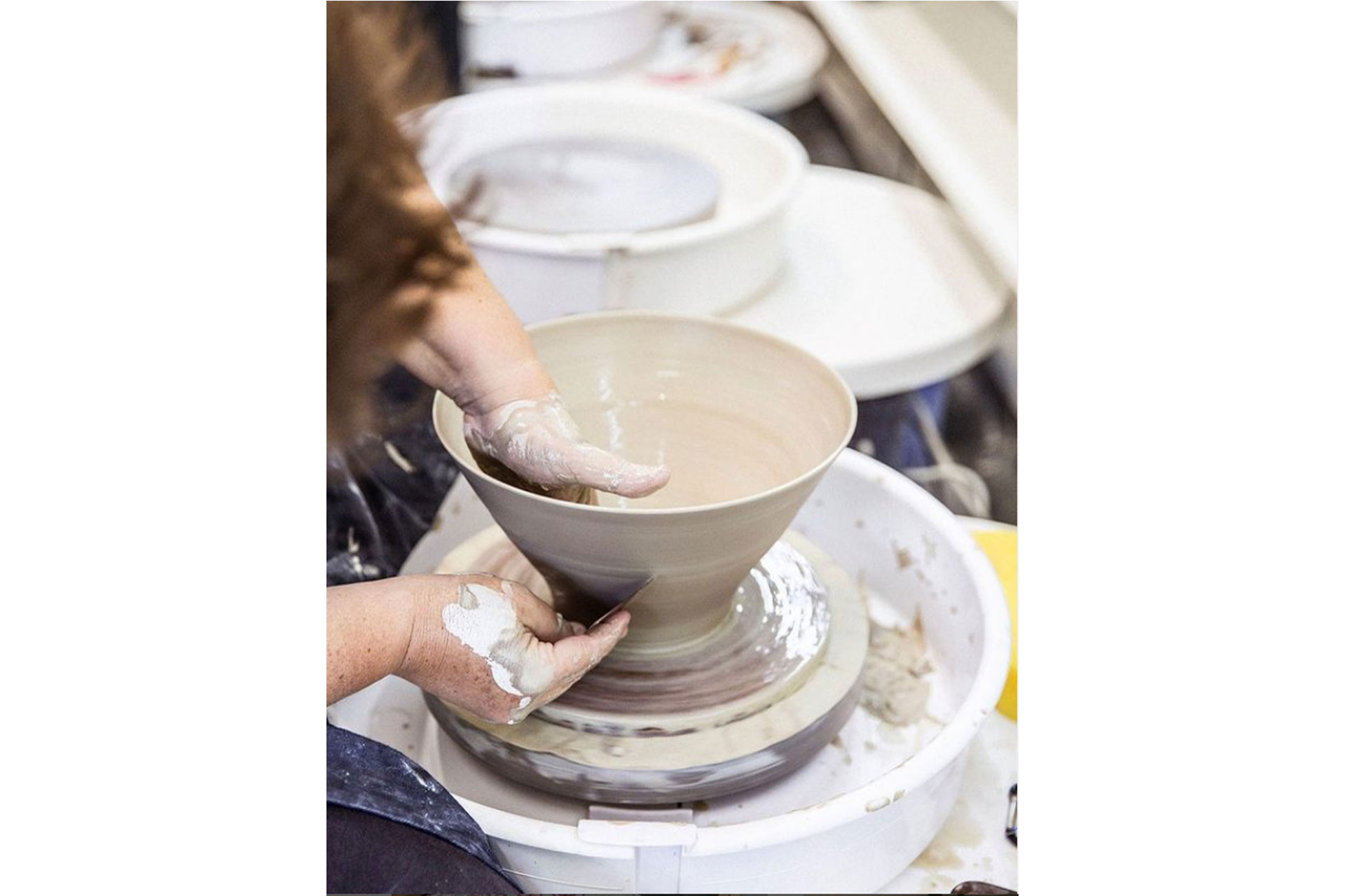 a close up of someone making a bowl at Kiln Pottery