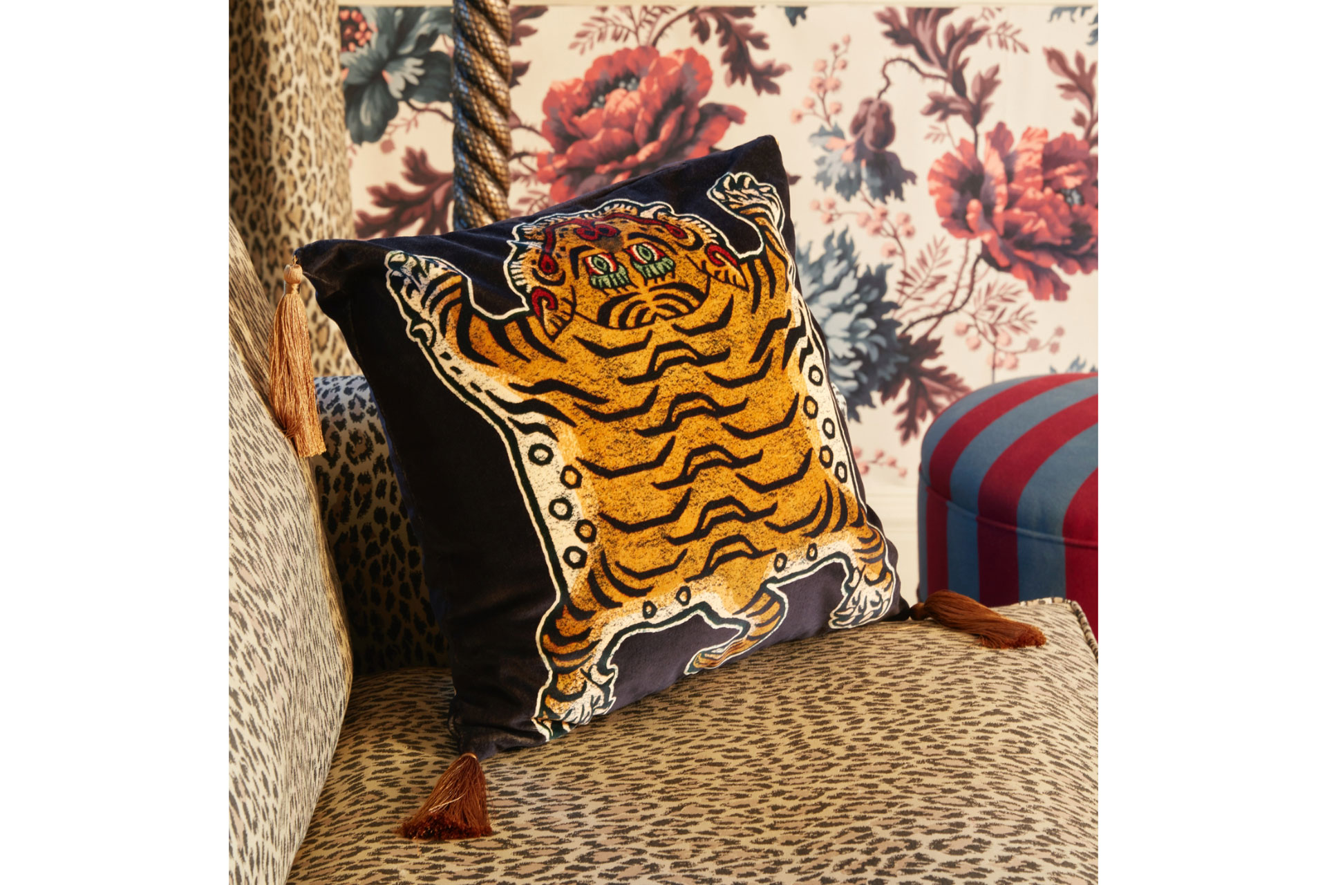 a cushion with a tiger print on a sofa by Liberty London