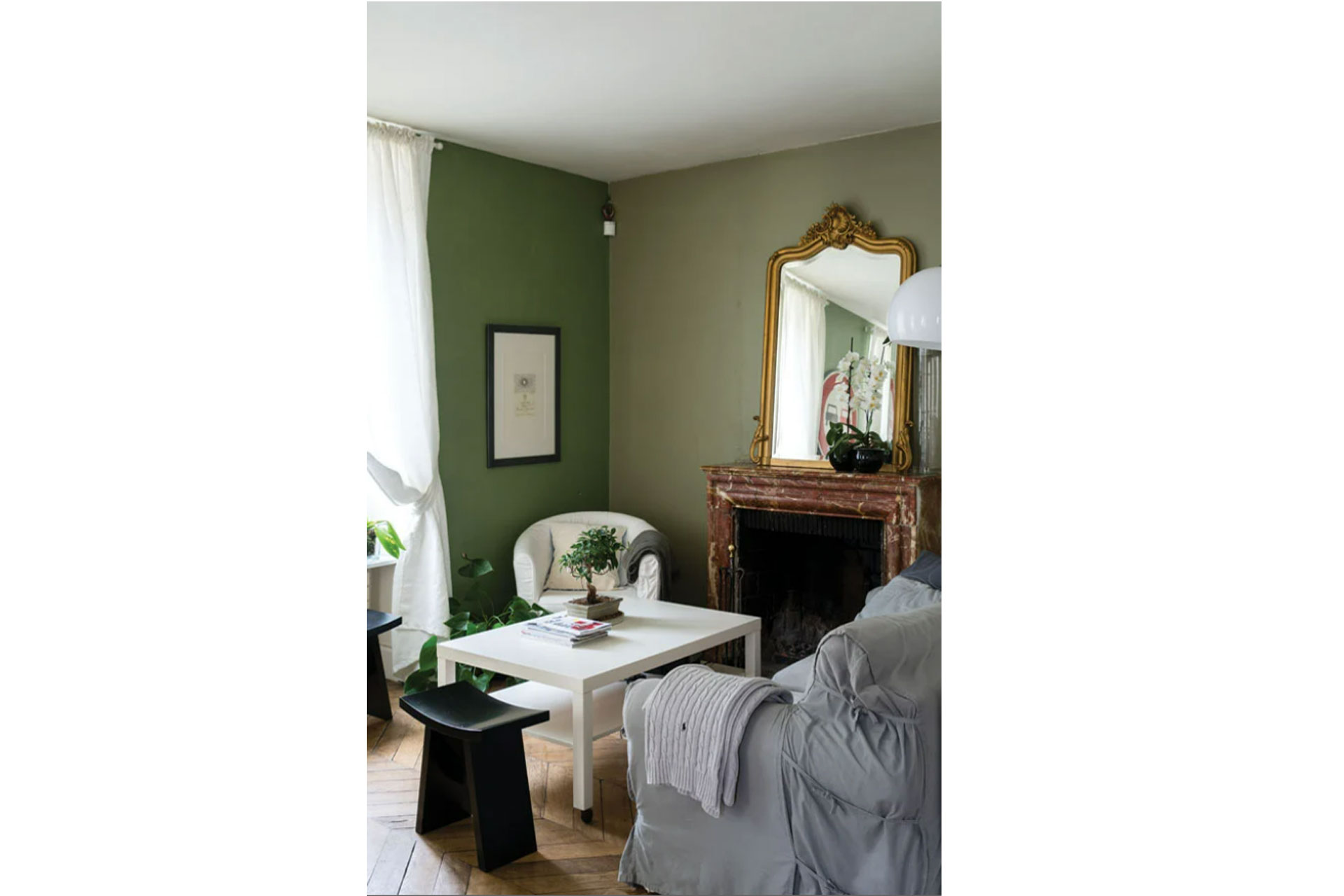 Lichen paint by Farrow and Ball in a grand living room with a large antique golden mirror and cream sofas