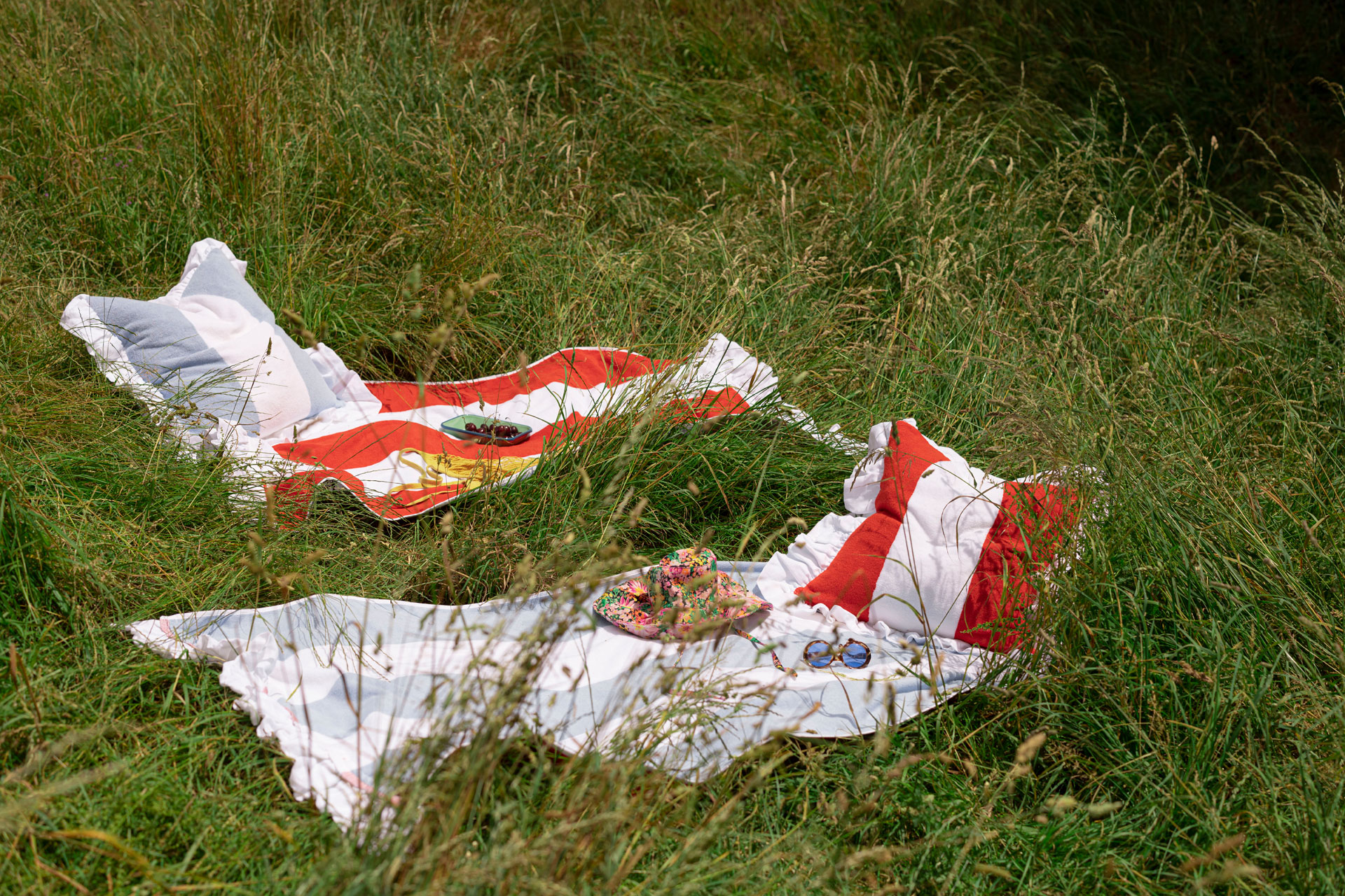 Cushions and fabric laid out on grass