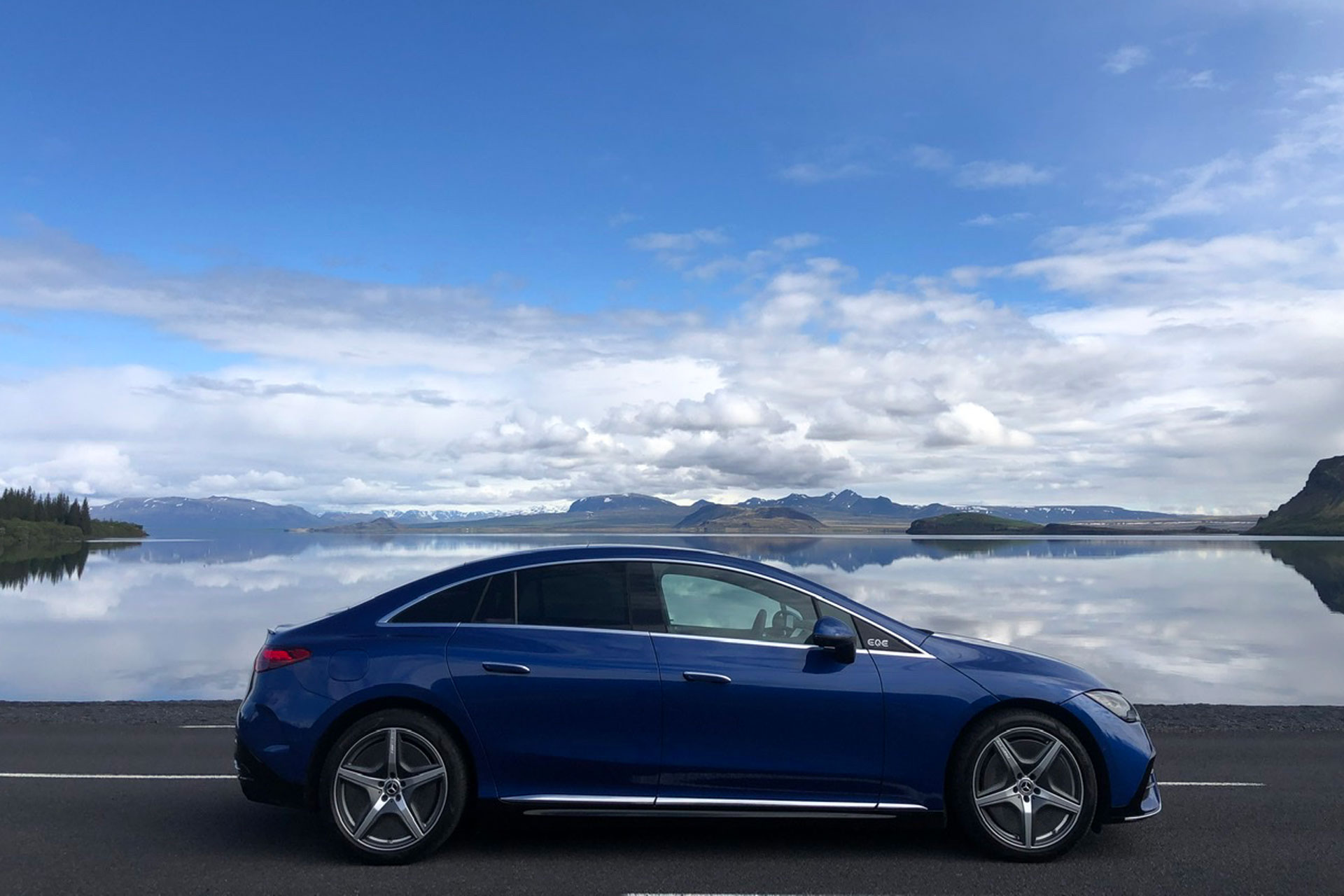 Side view of the Mercedes EQE 350+ behind a Norwegian backdrop