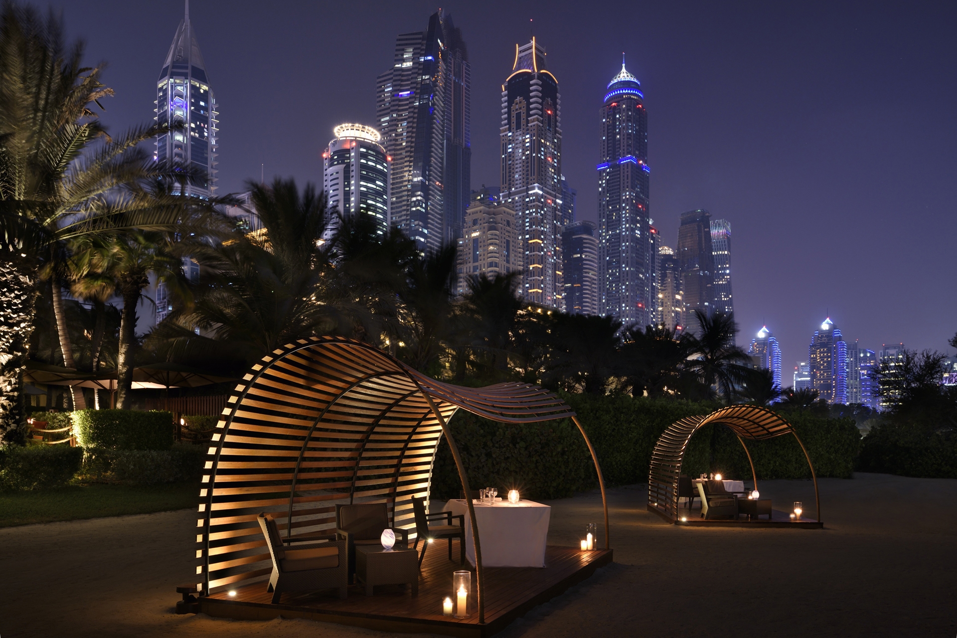 Beach Bar & Grill gazebos against the night time skyline