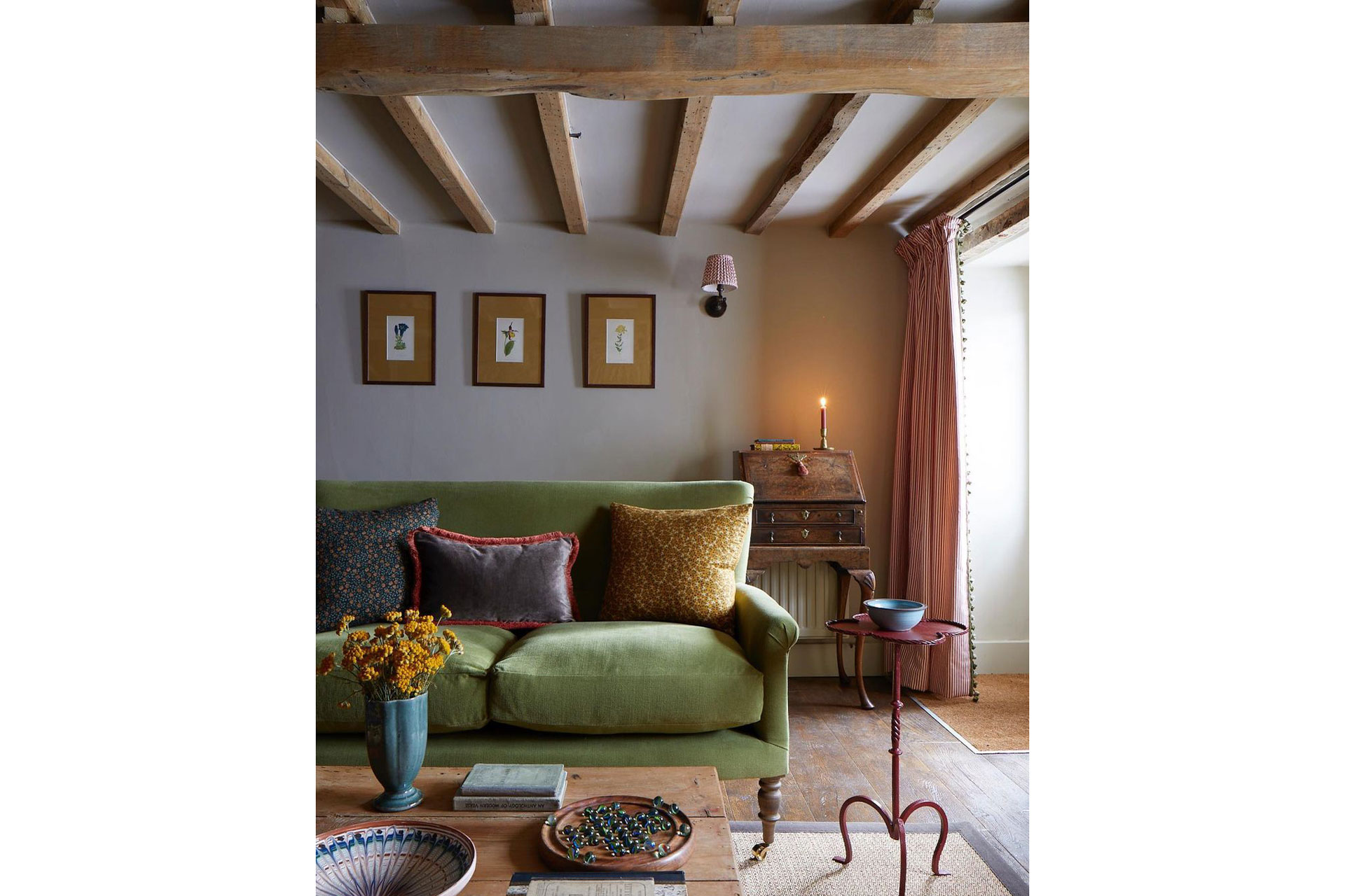 a living room with wooden beams and a green sofa from Sofa.com