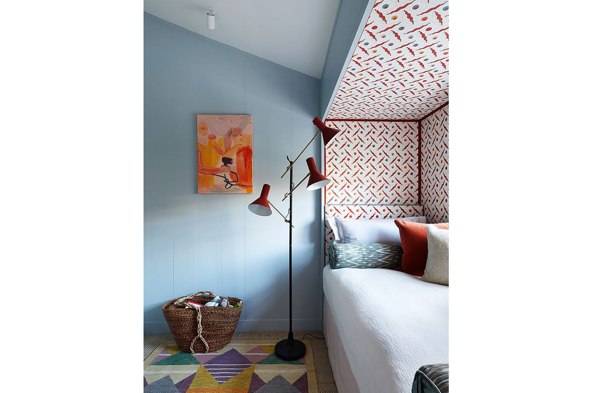 a blue bedroom with a small bedroom in the corner and a red standing lamp