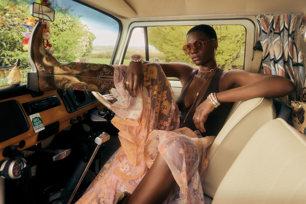Woman posing in a car in cowboy boots