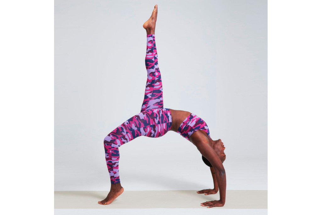 Woman performing yoga in purple activewear