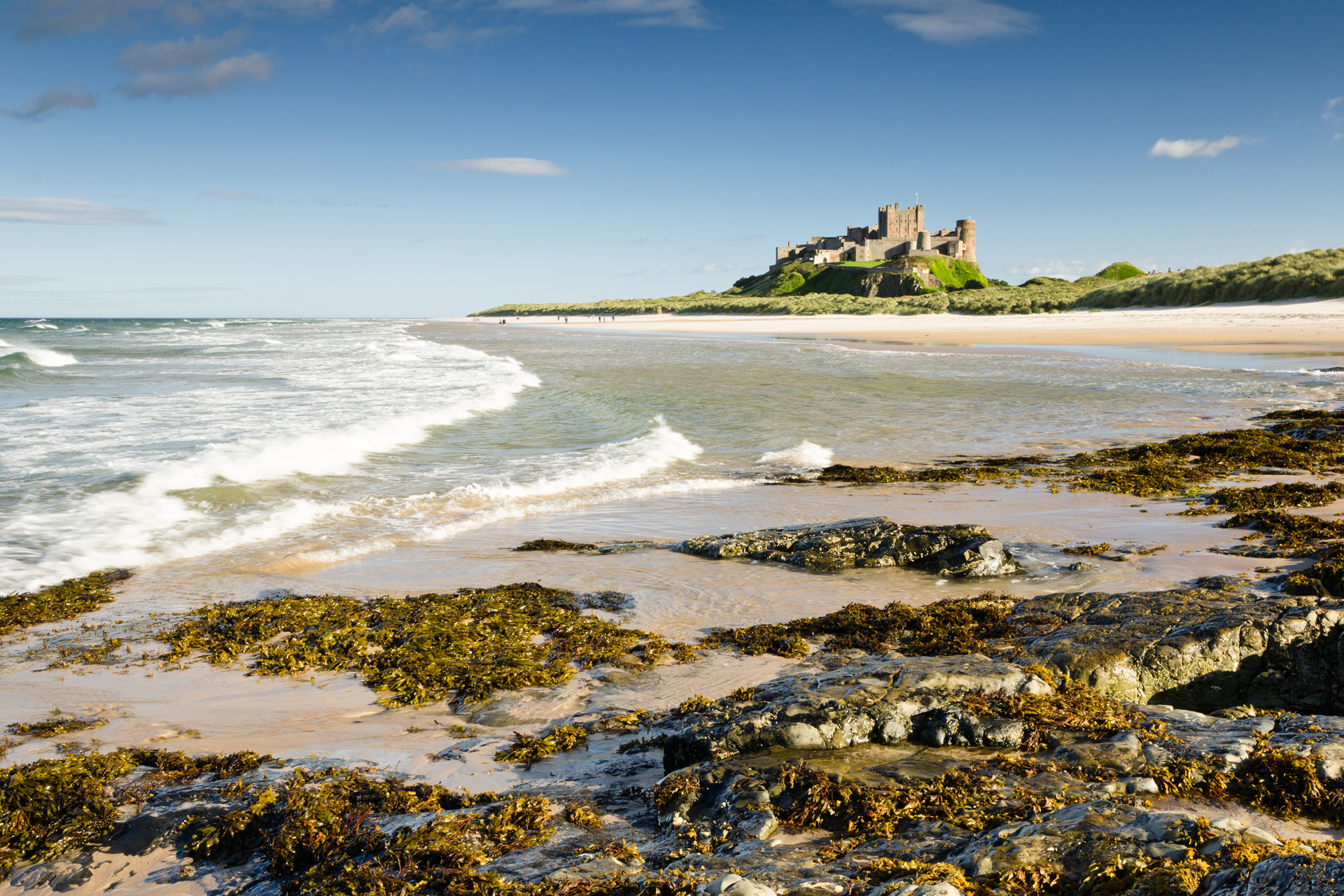 Bamburgh Castle taken here from the north beach dates back to the 6/7th century