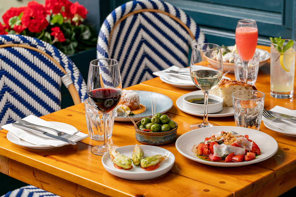 spread of drinks and plates at italian restaurant cin cin