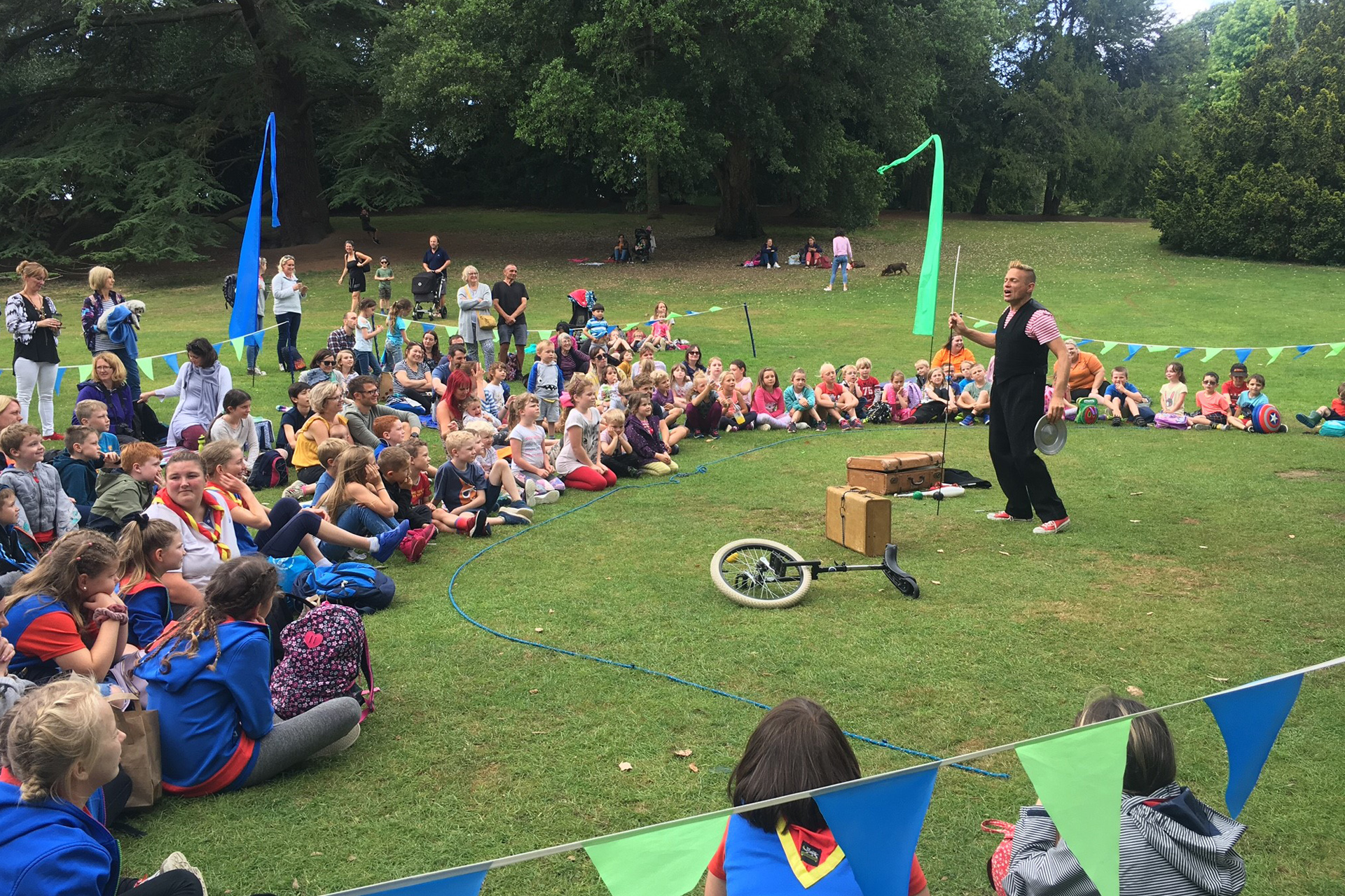 A man performing circus skills with a crowd