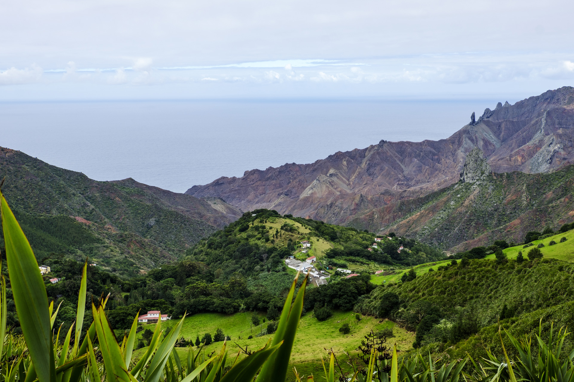 Looking towards Sandy Bay in St Helena and South Atlantic Ocean over volcanic features including geological pillar landmarks