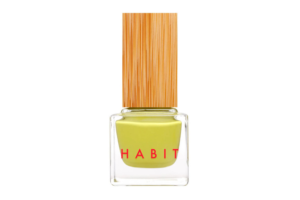 Bottle of yellow nail varnish with wooden cap