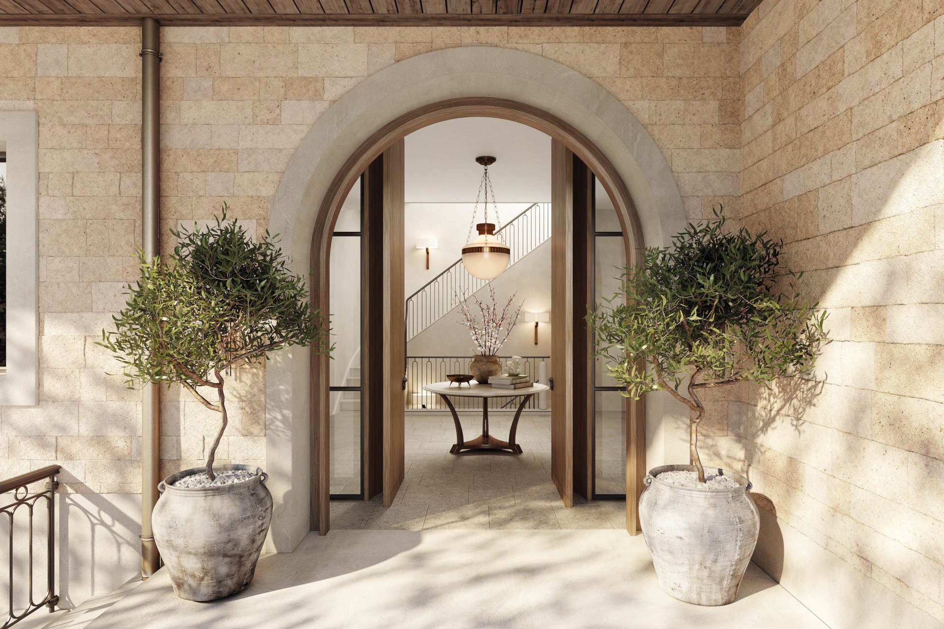 View of the entrance hall from the front door, with a curved doorway and a potted plant each side
