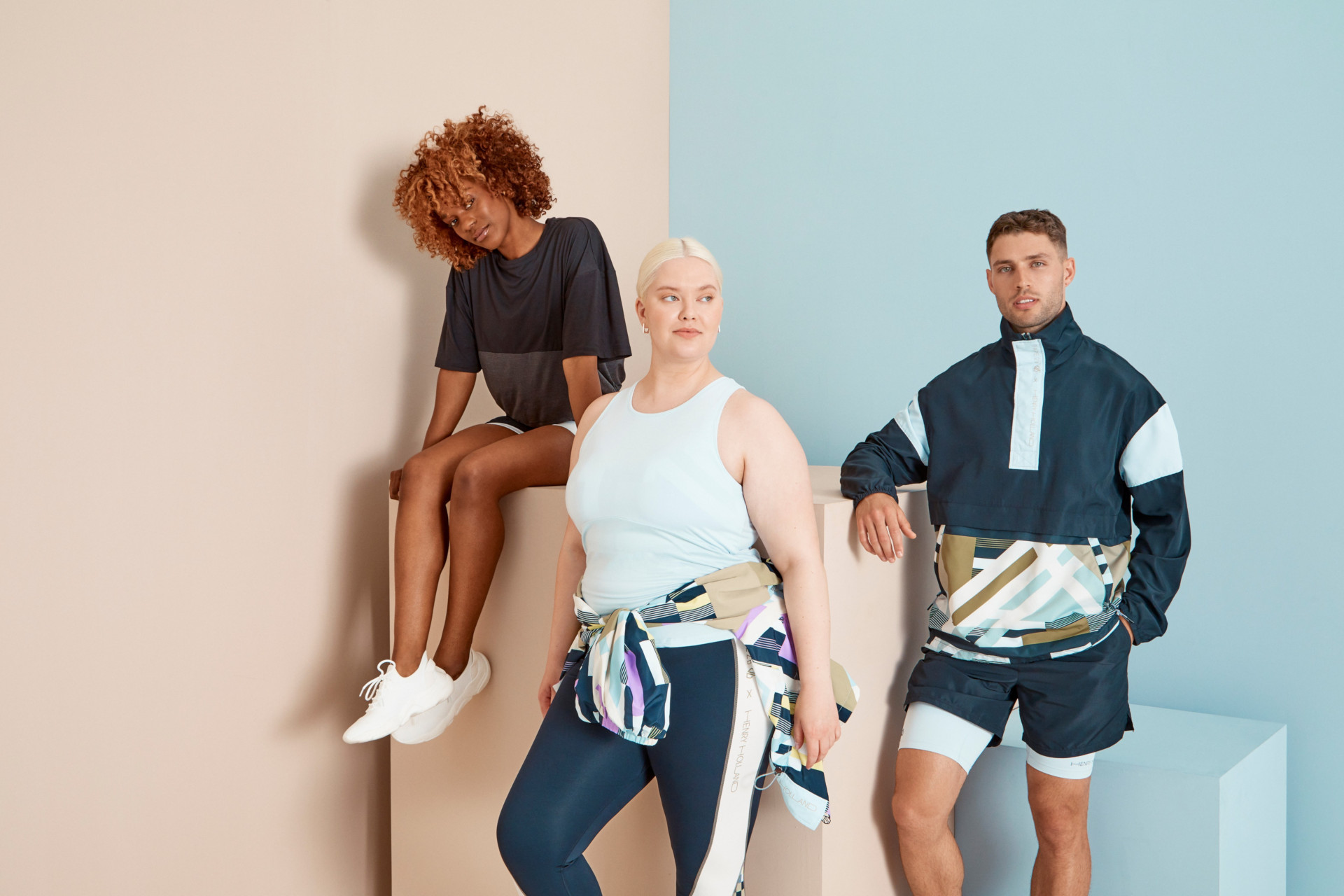 Models in activewear stood together in front of colourful background