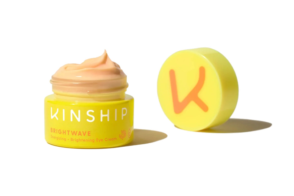 Yellow tub with a lid, with peach-coloured cream inside