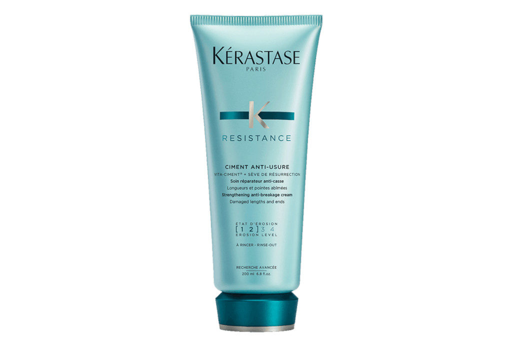 Green-blue bottle of conditioner with cap in a darker shade