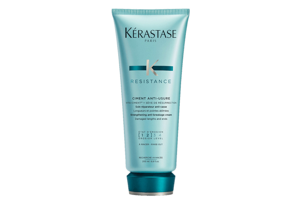 Green-blue bottle of conditioner with cap in a darker shade