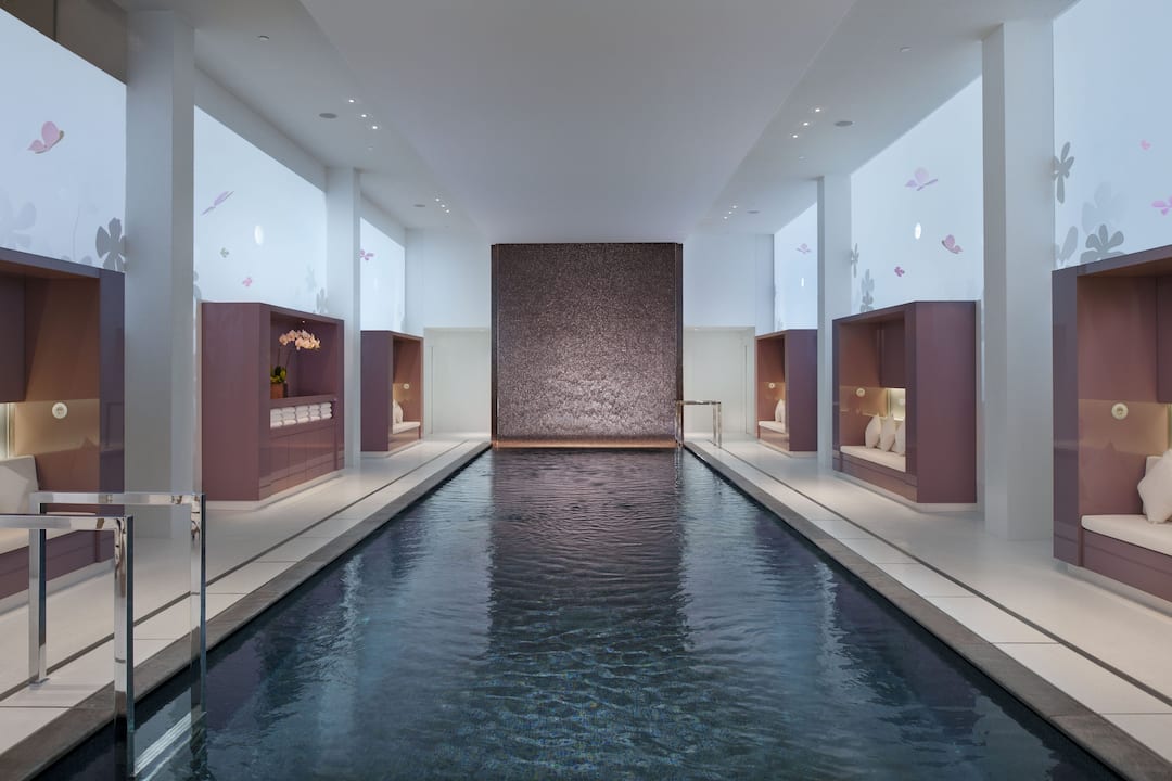 A serene swimming pool with pillars alongside