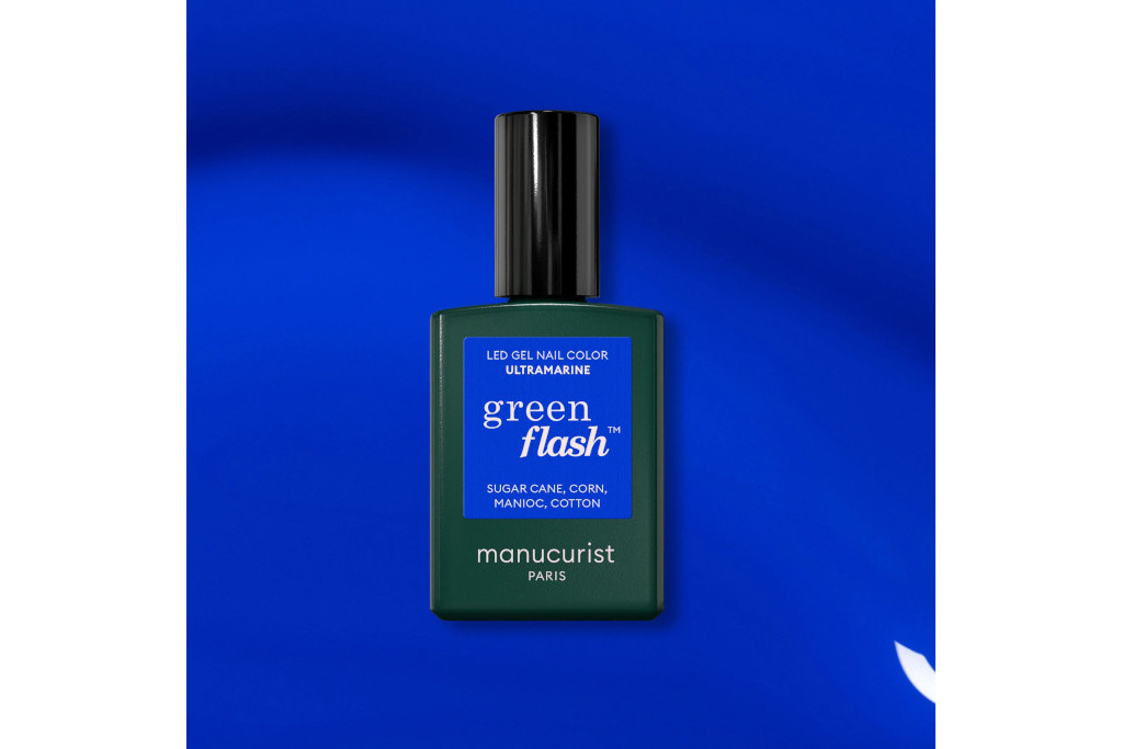 Bottle of blue nail varnish on blue background