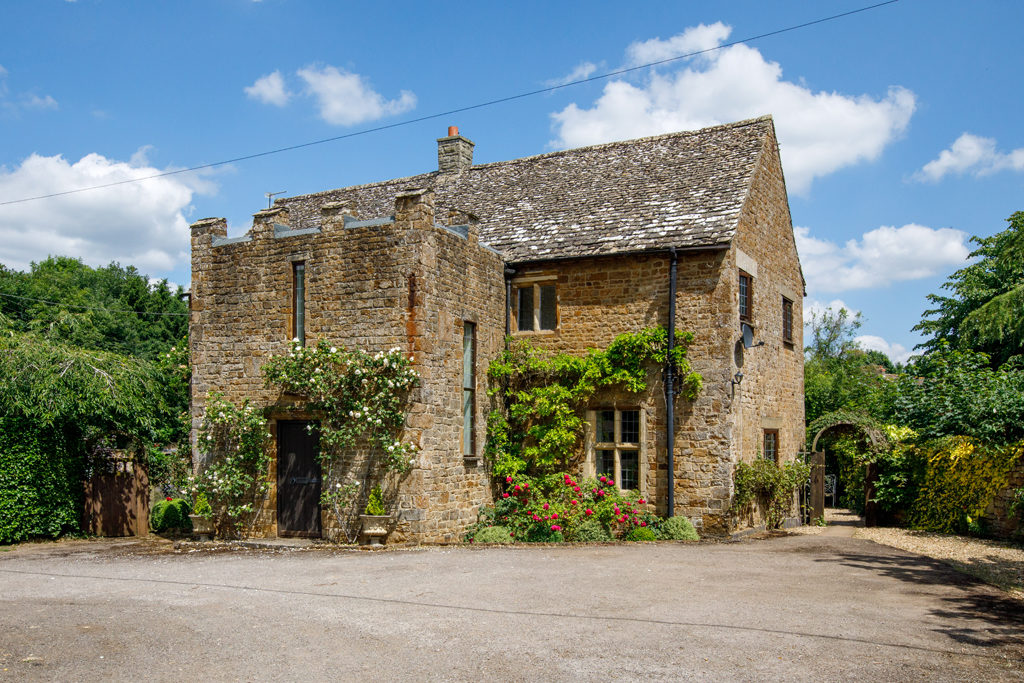 wisteria clad country home with castellated attachment in banbury, oxfordshire