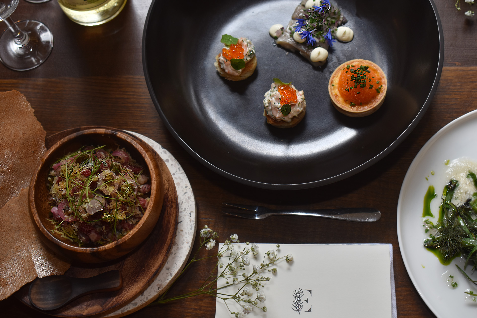 refined dishes on dark plates