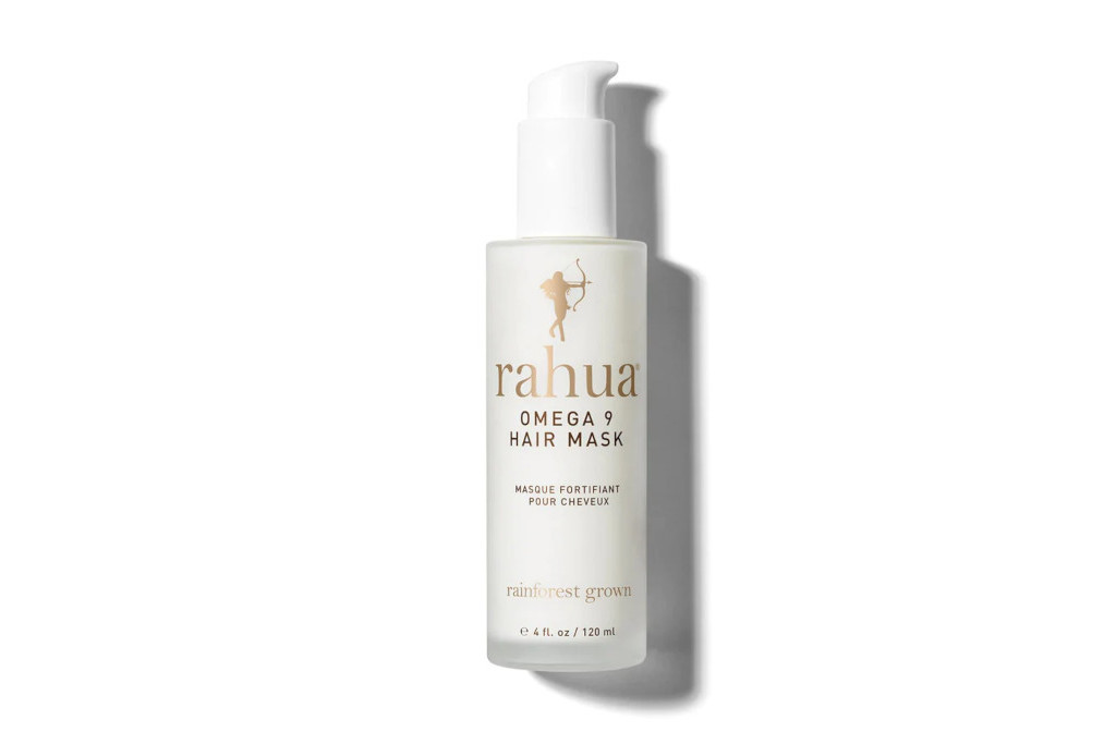 White pump bottle with Rahua logo and product description on front in black and gold text