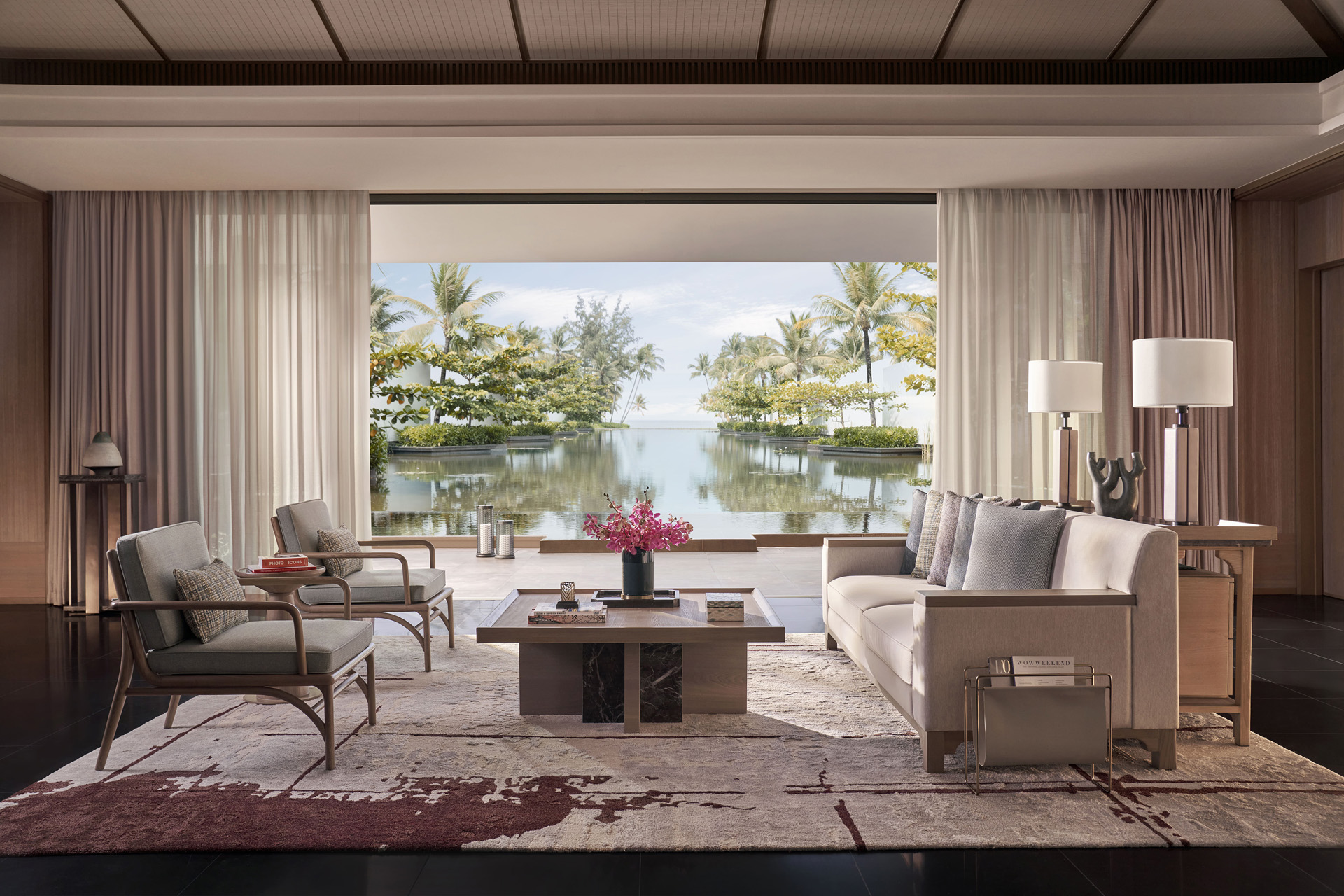 A sitting room with doors opening to a private infinity pool