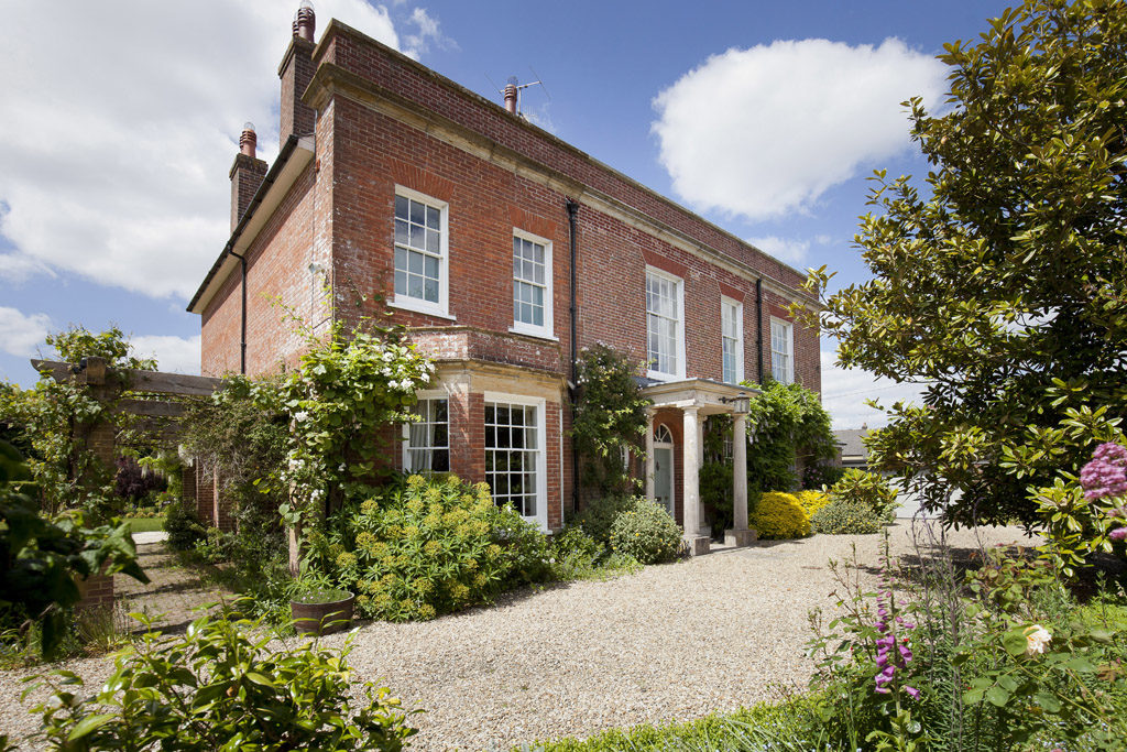 red brick georgian home with wistertia clad and stone front drive in dorset