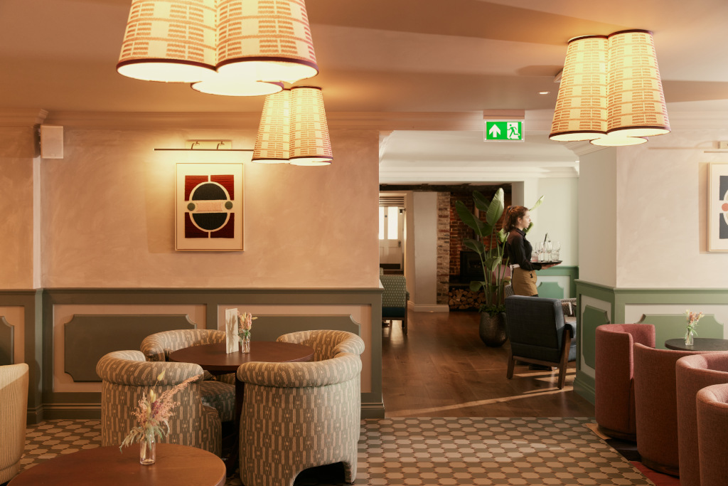 hotel reception living area with arm chairs and pastel walls at the georgian coppa club haslemere 