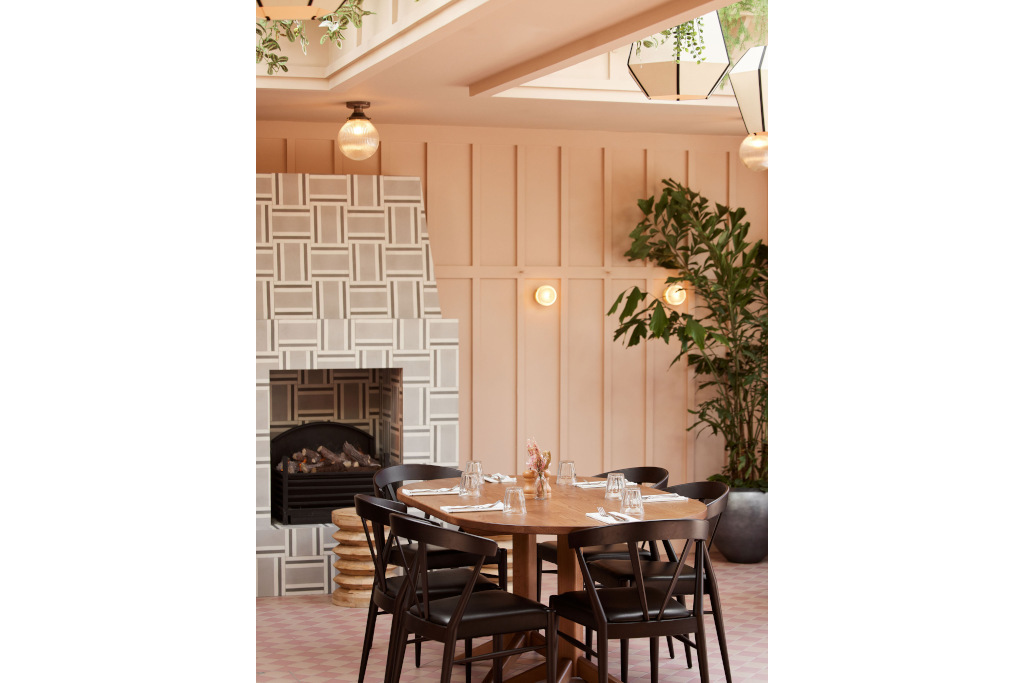 pink panelled room with pink checkered floorboards with table and chairs in middle