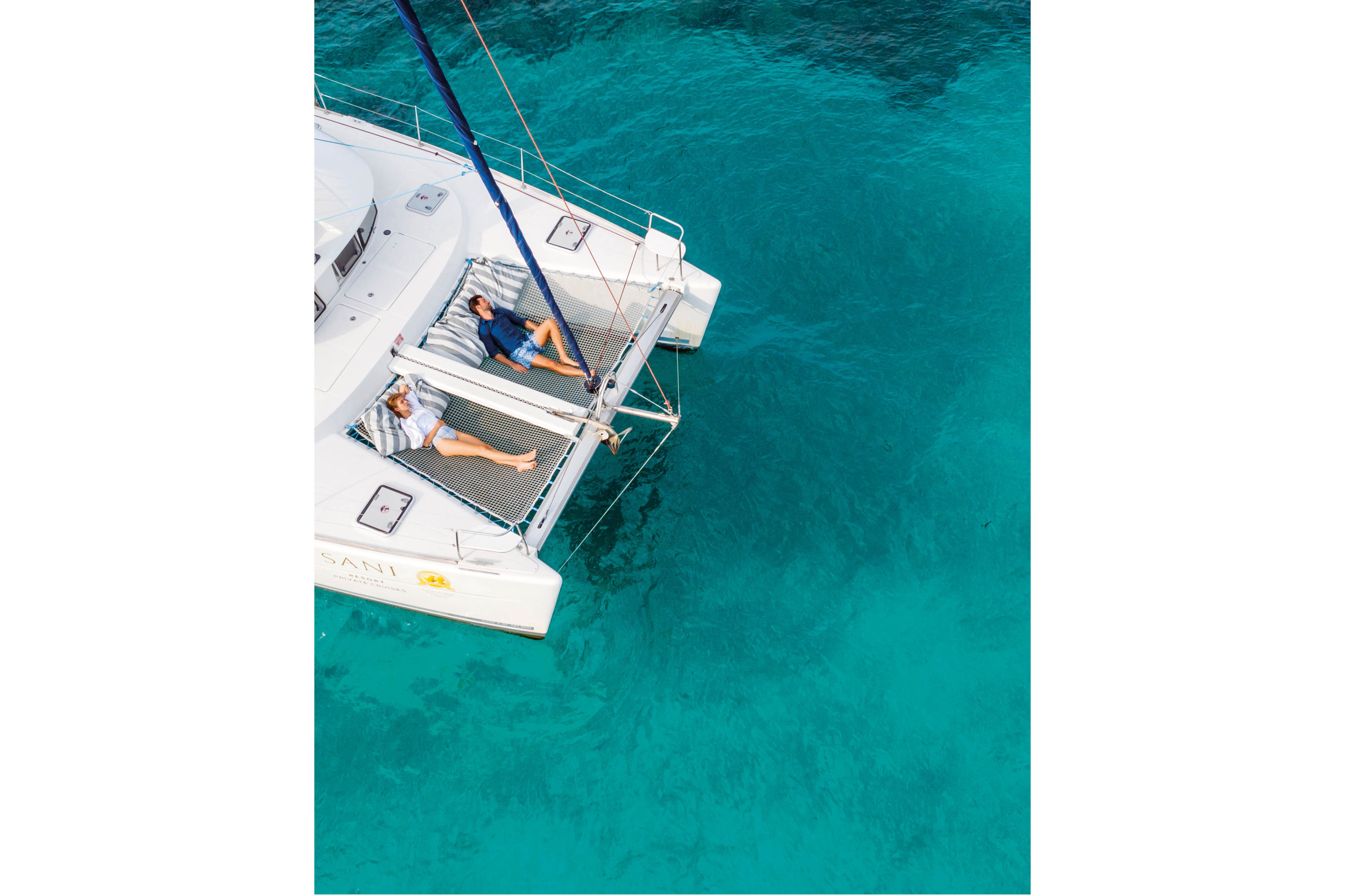 A couple on a yacht on clear blue water