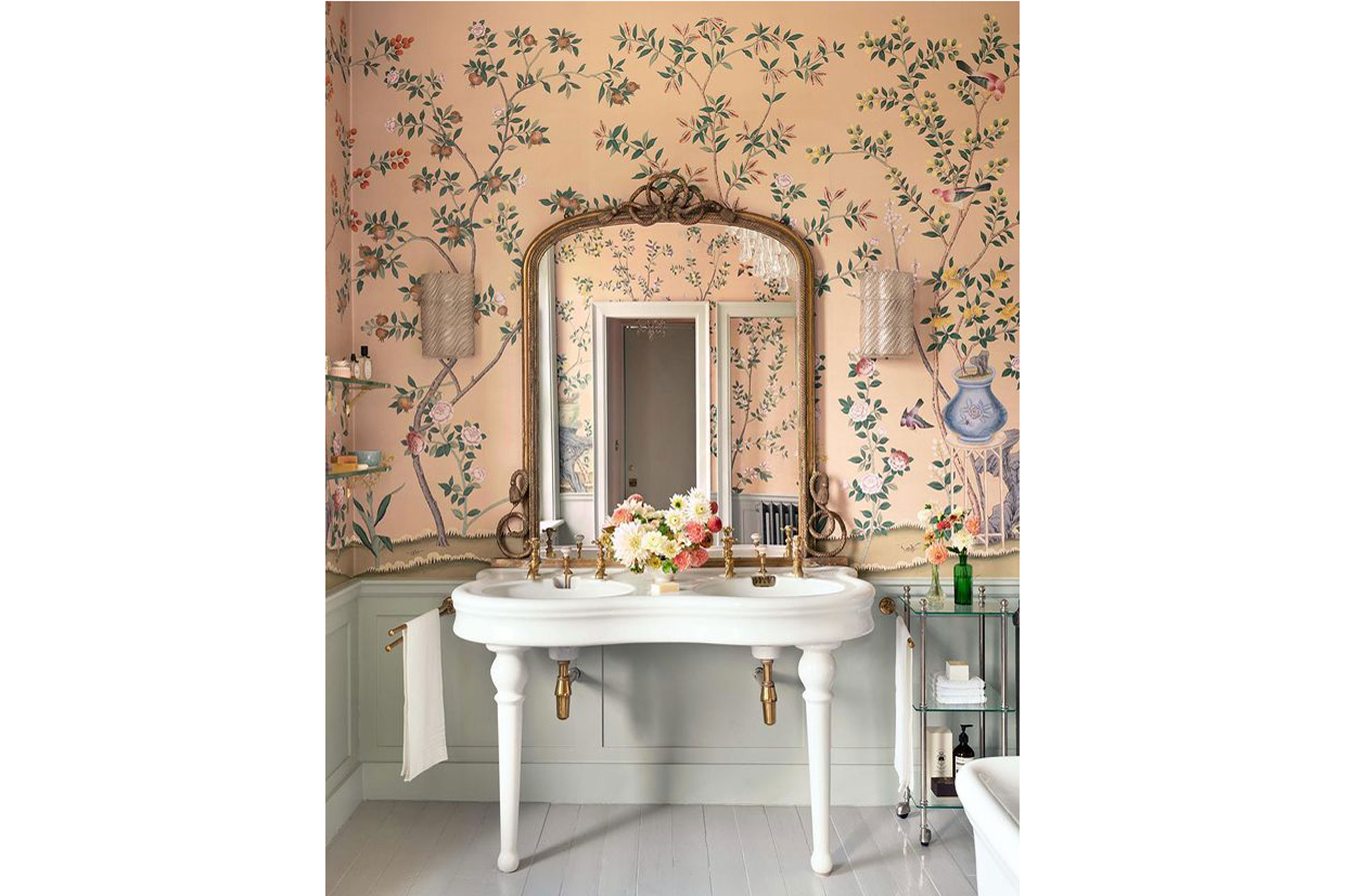 Characterised by Springtime ebullience, the ‘Jardinières and Citrus Trees’ Chinoiserie brings an energetic charm to interiors. Filled with tulip and peony flowers, it also depicts colourful pomegranates, peaches, green lemons, lychees and plums – fruits rich in symbolism within Chinese culture. Hand painted here upon a Gentlemans Pink dyed silk, a North London bathroom mirrors the sprawling garden over which it looks in a splendid play on art imitating life.