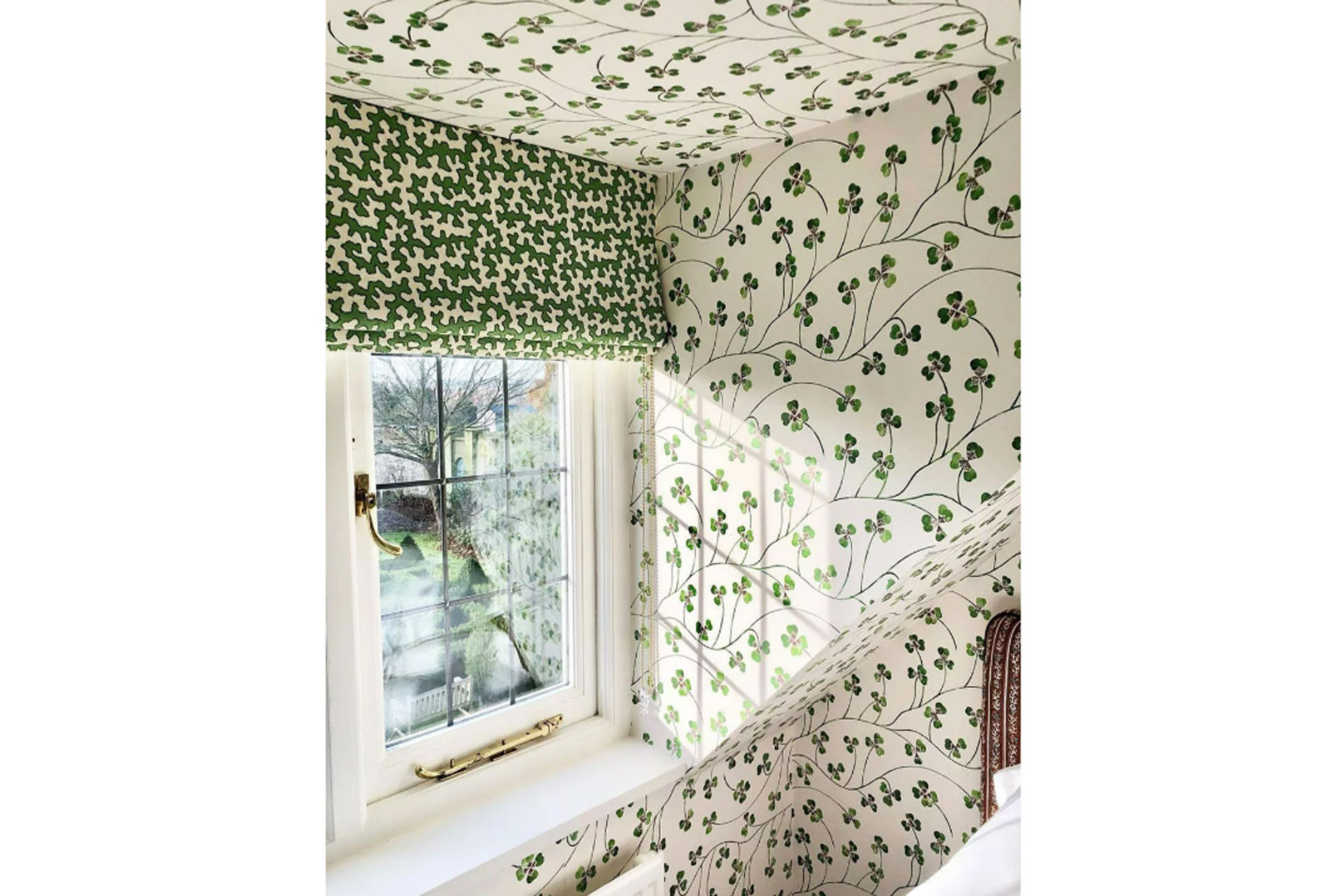 Katie Hawkins Lucky Leaf Wallpaper that's framed around a window with a blind in an English Cottage