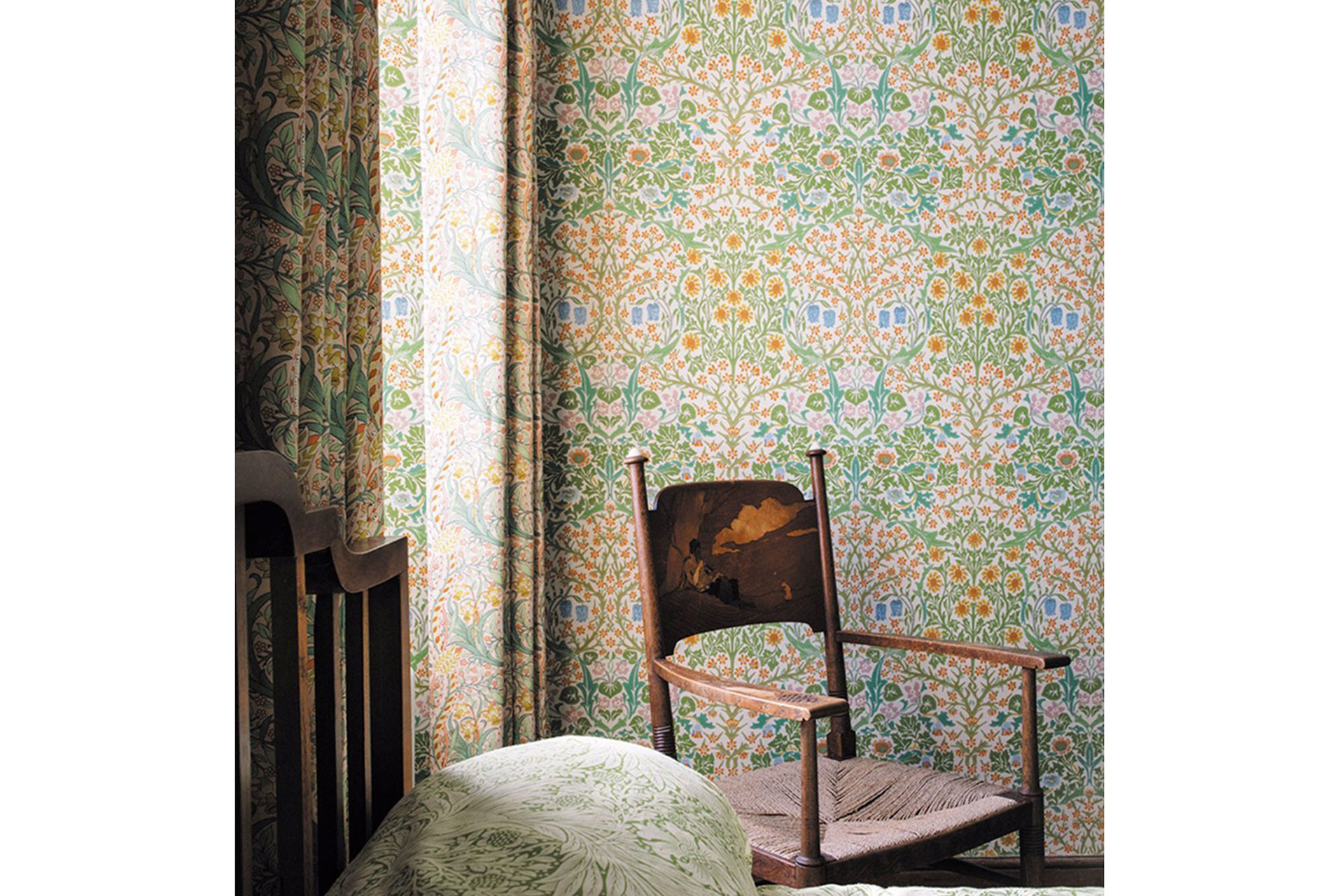 Morris & Co Blackthorn wallpaper with an antique wooden chair in front